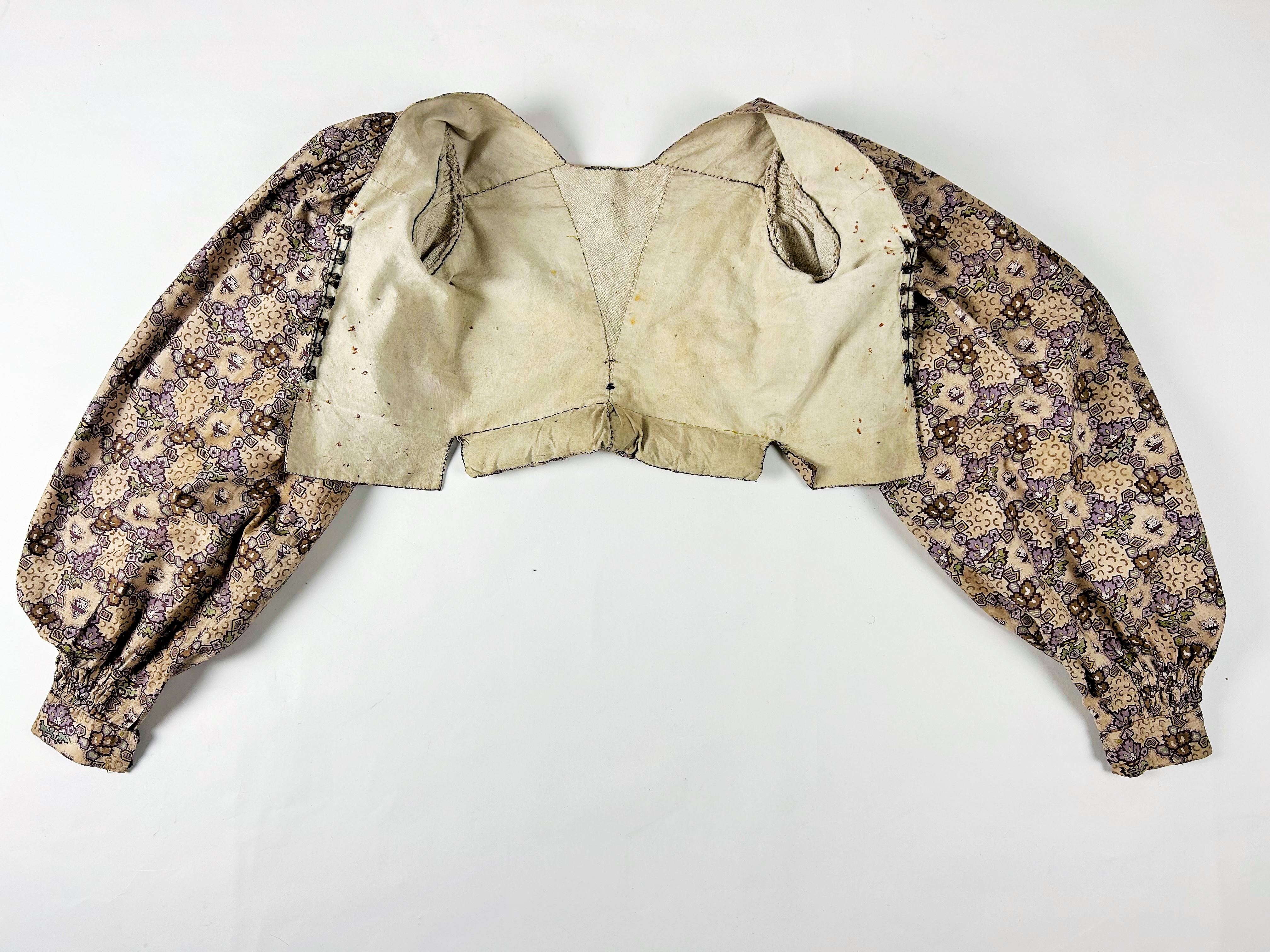 Circa 1830
France or Provence

Amazing Indian and unbleached linen camisole with interesting beading and ties allowing the skirt to be positioned in the back and dating from the Romantic period. Obvious influence of the Paris fashion for this