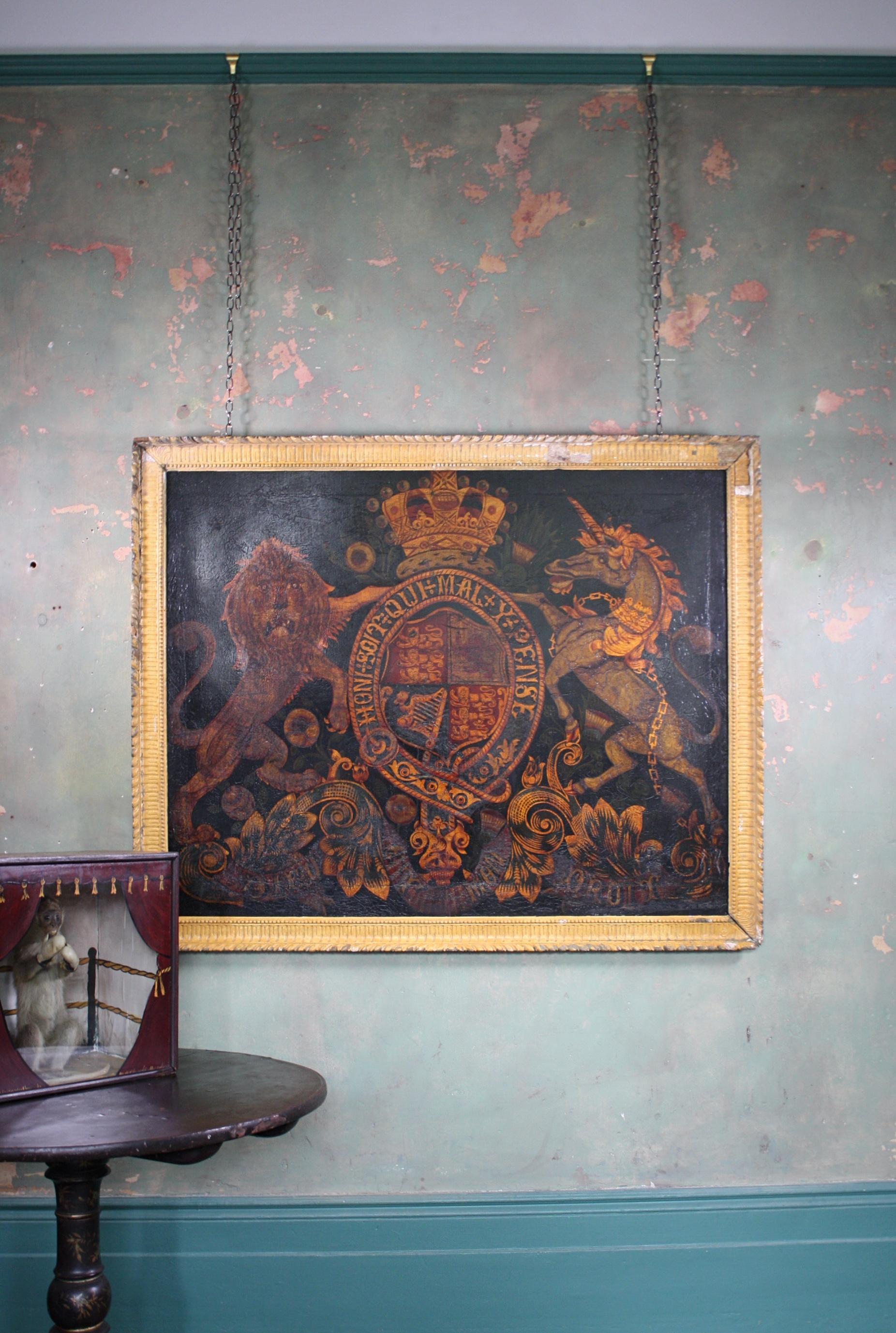 A large and impressive early Victorian oil on canvas Royal coat of arms, housed in a later yet period softwood carved and gesso frame.

The typical image shows a lion and unicorn, centred with the British monarch crest and underneath bearing the