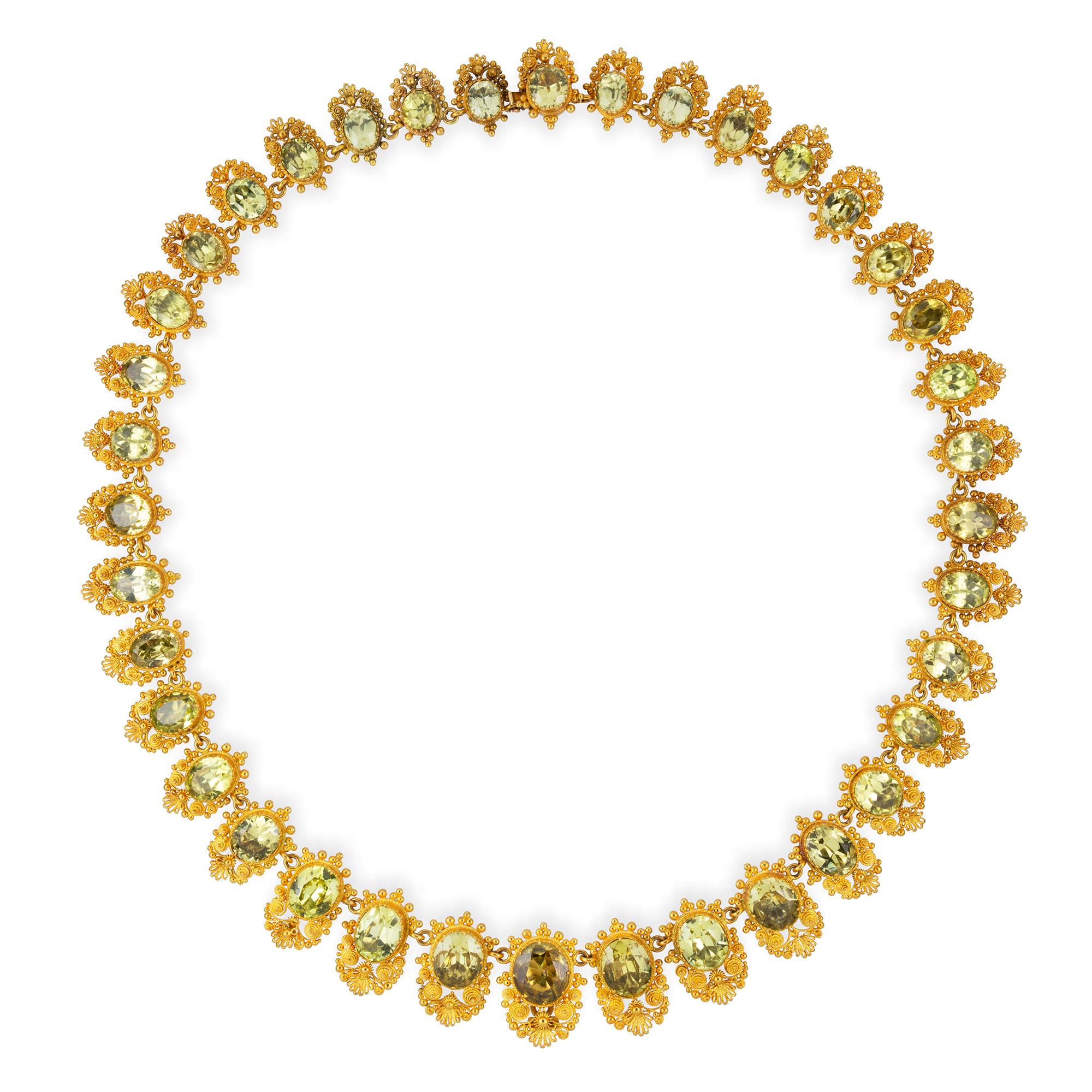 An early Victorian chrysoberyl necklace, the thirty-eight graduating chrysoberyls ranging approximate from 5.1 x 6.3mm to 8.7 x 10 mm each set within a close-back cut-down setting with very fine filigree decorations, all in yellow gold, to a hidden