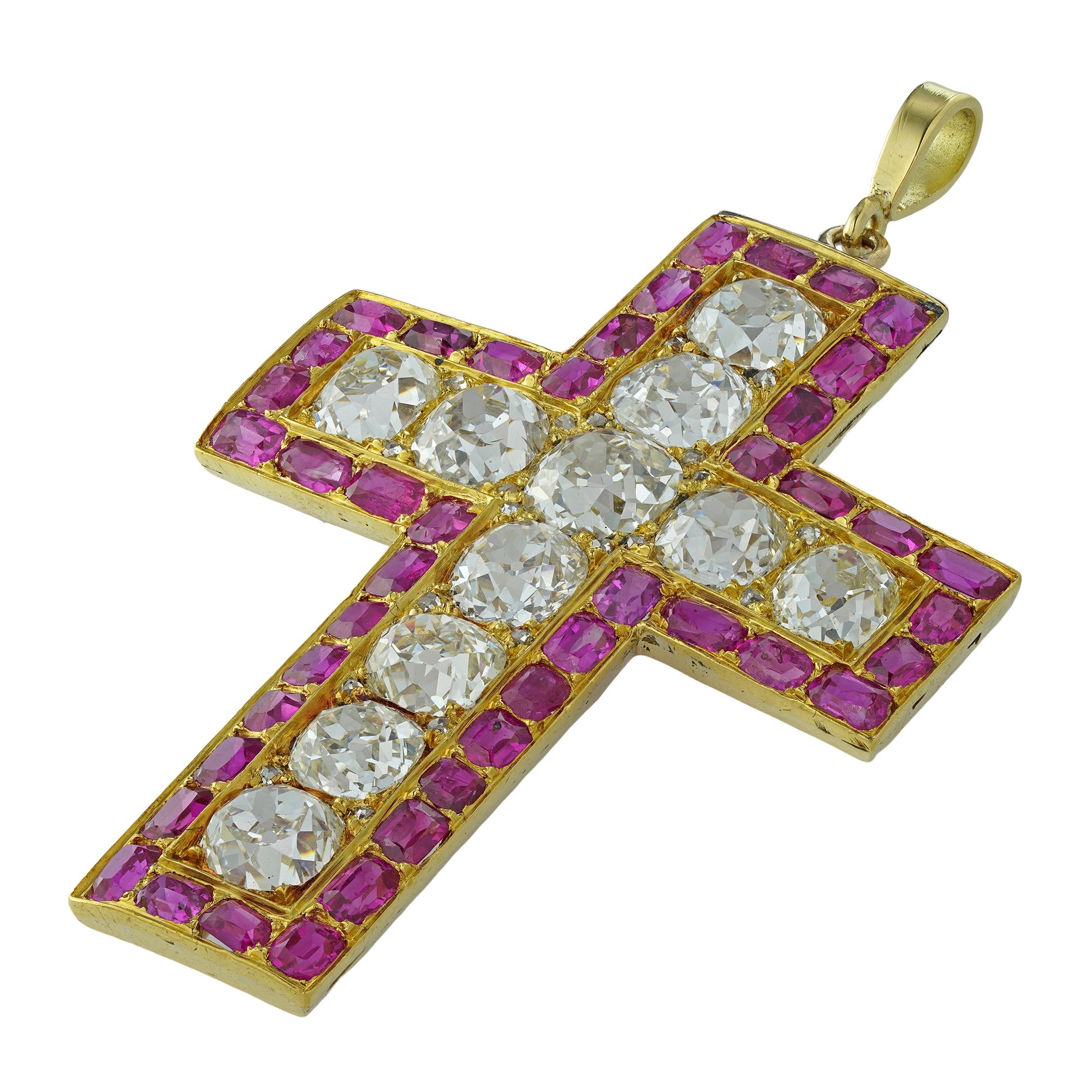An early Victorian diamond and ruby cross, the eleven old European-cut diamonds estimated to weigh 6.25 carats in total, surrounded by a frame consisted of forty-four rectangular faceted rubies, all mounted in yellow gold, with golf pendant fitting,