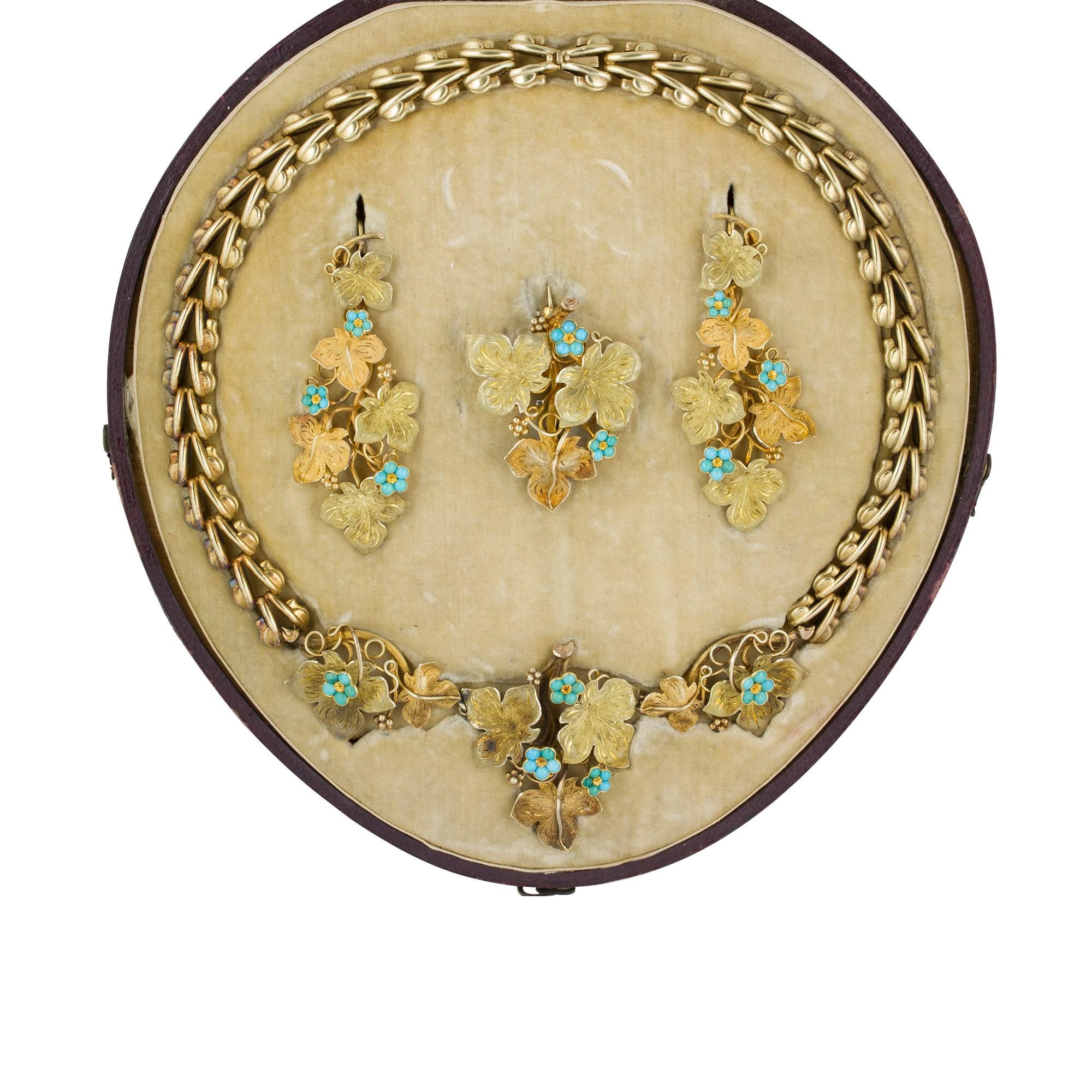 An early Victorian gold turquoise floral suite, consisting of a necklace, brooch and a pair of earrings, the necklace with three graduated sections of vine leaves and five forget-me-not flowers to the centre suspended by an open fancy link chain,
