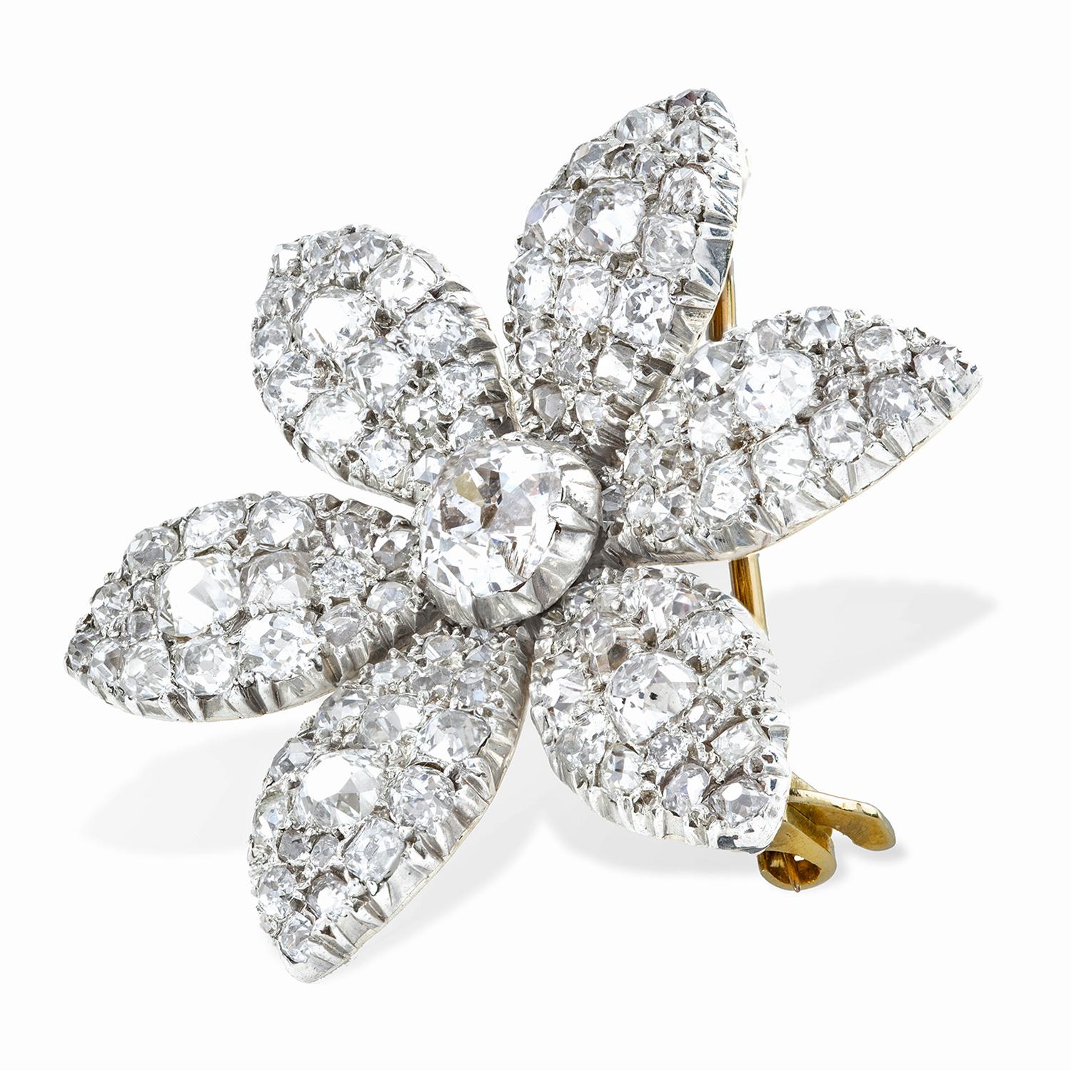 An early Victorian jasmine petal diamond brooch, the brooch in the design of a six-petalled diamond encrusted flower head with a central old brilliant-cut diamond, the diamonds estimated to weigh a total of 6.00 carats, all cut-down set in silver to