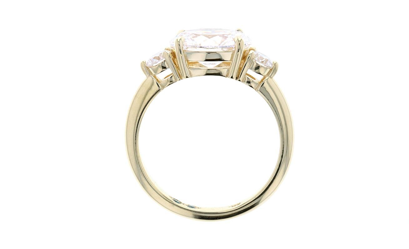 An East West Oval Diamond Engagement Ring in a Three Stone Setting elevates a classic look into a more contemporary design. Who says you can't have it all? A large oval diamond center stone is set in a modern East West orientation and flanked by two