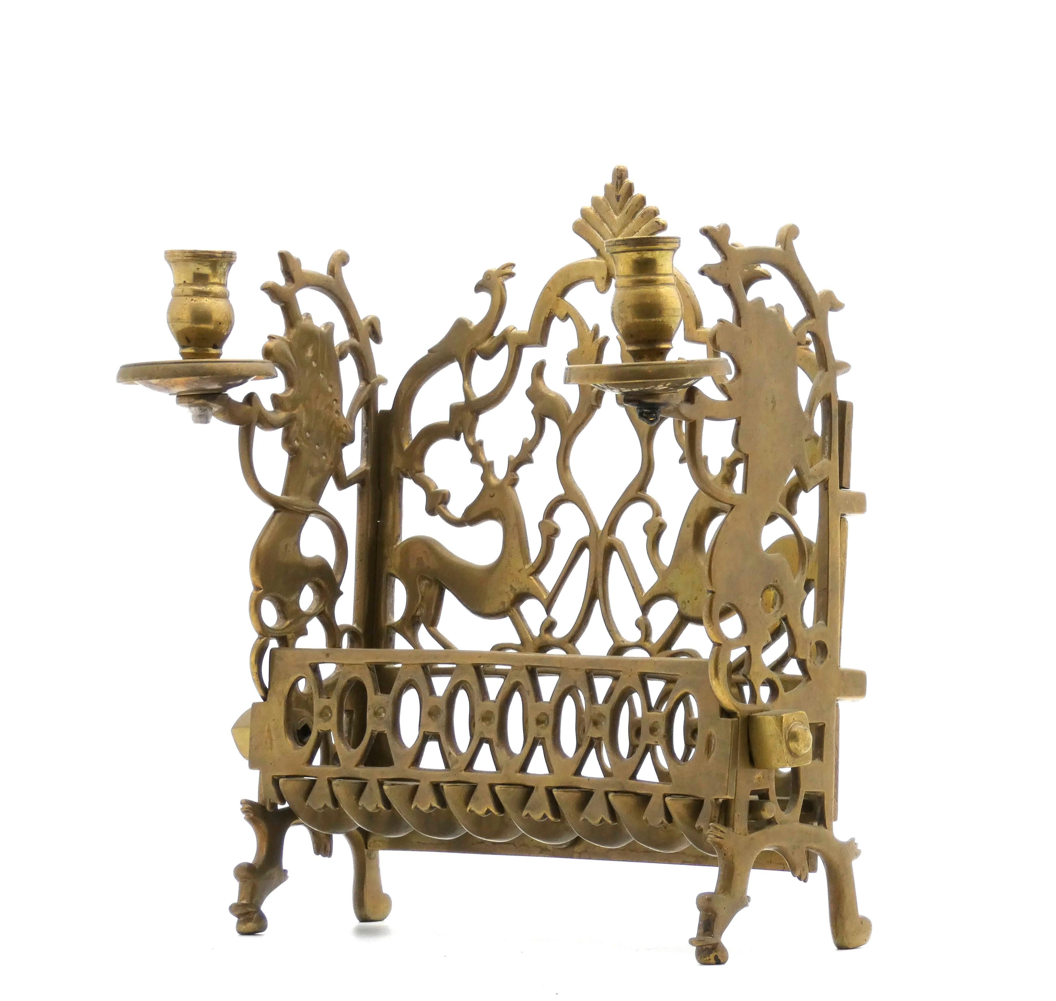 An Eastern Galician or Ukraine dually made for use as a Hanukkah Lamp or on Shabbat as two candlestick holders with a special sand casting method.

Beautifully cast back plate features two kneeling deer their heads turned gracefully backward, their