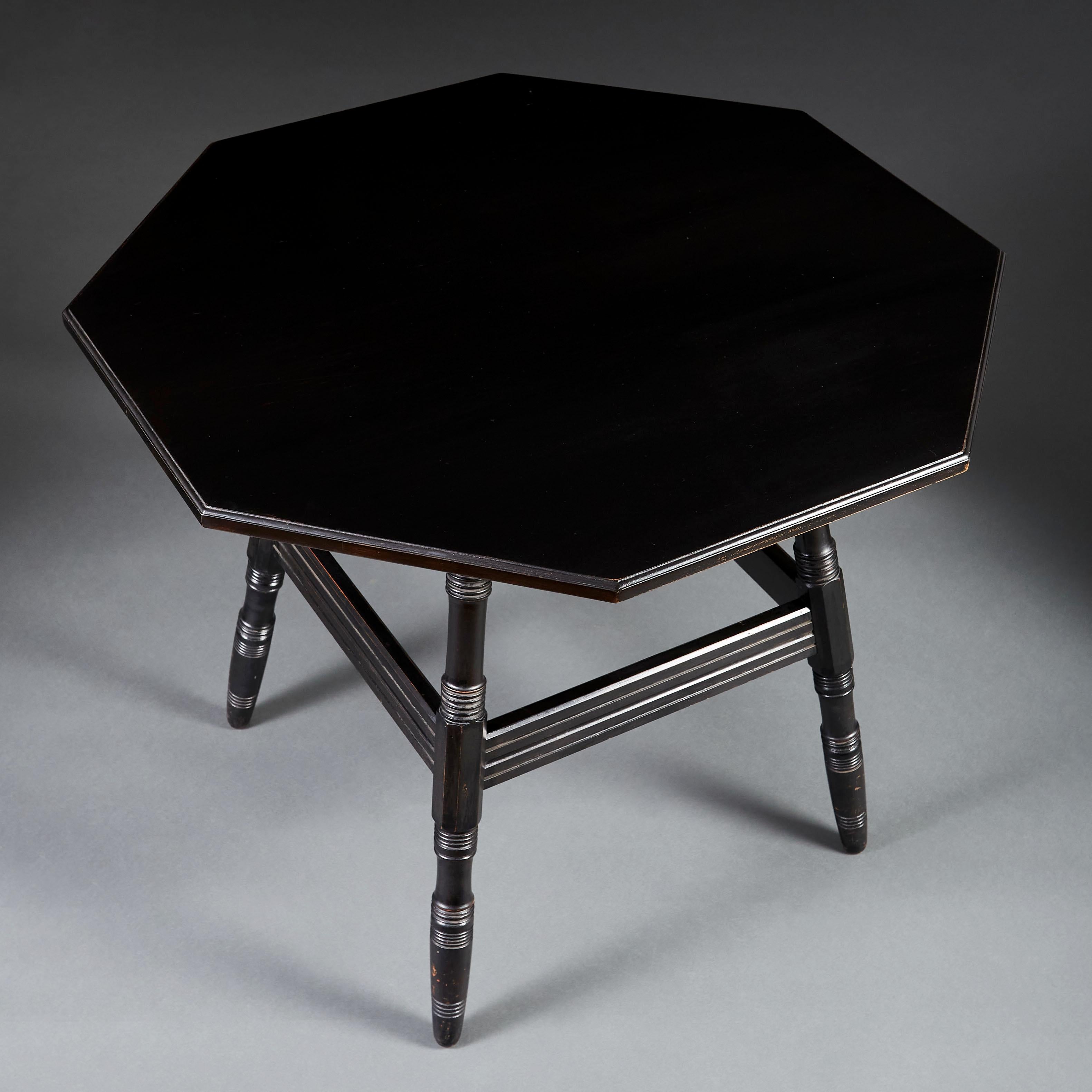 An ebonised Arts & Crafts centre table of octagonal form with turned legs and stretchers, in the manner of Philip Webb.

Philip Webb (1831 – 1915) was a talented and versatile designer who not only created buildings and furniture but also