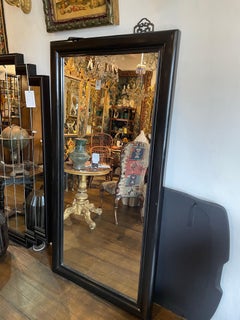 An Ebonised Mirror with Mouled Framed