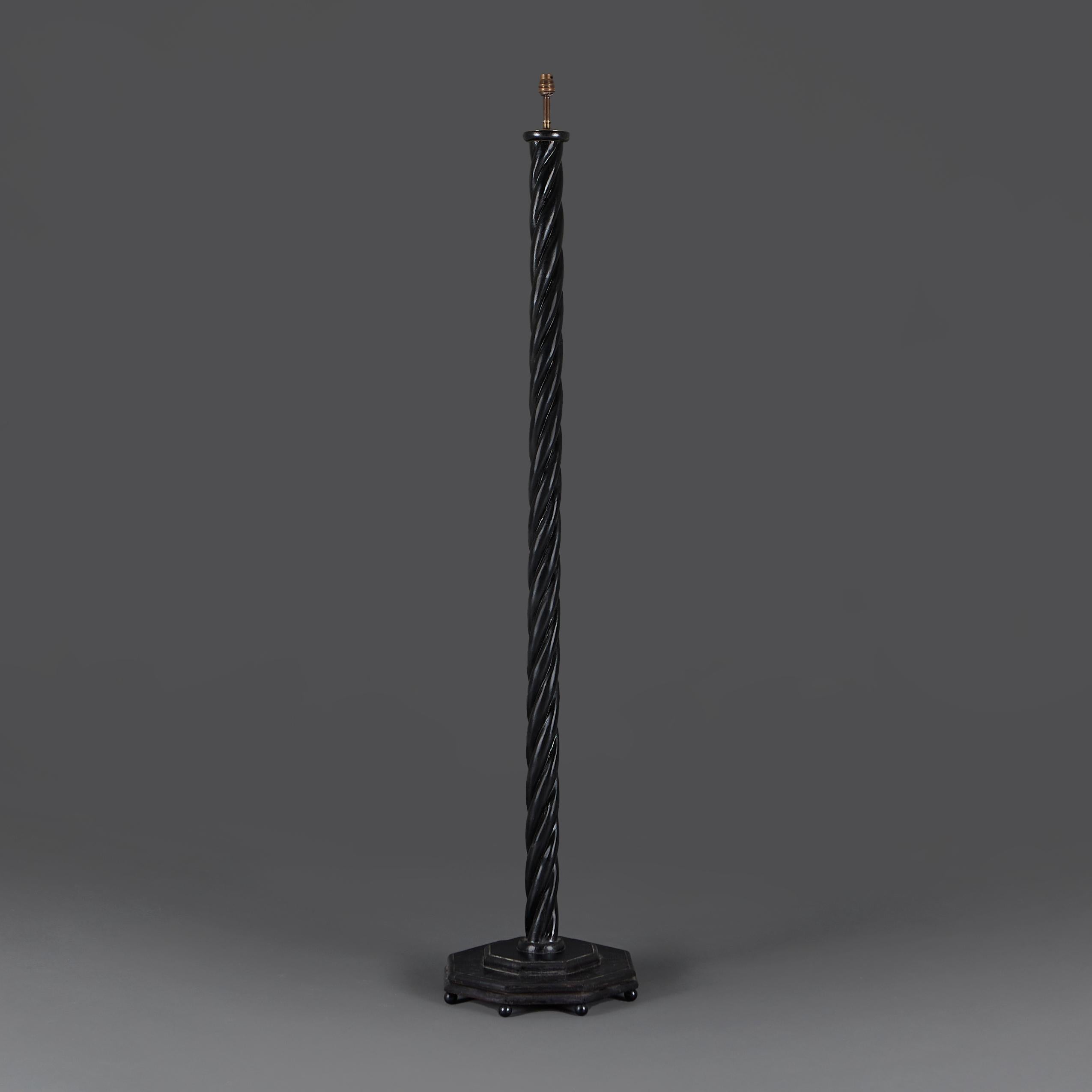 An Anglo Indian ebonised standard lamp, with twisted stem, all supported on an octagonal base with ball feet.

Please note:

Currently wired for the UK with patinated brass plate and BC bulb fitting, with bronze twisted silk flex and black foot