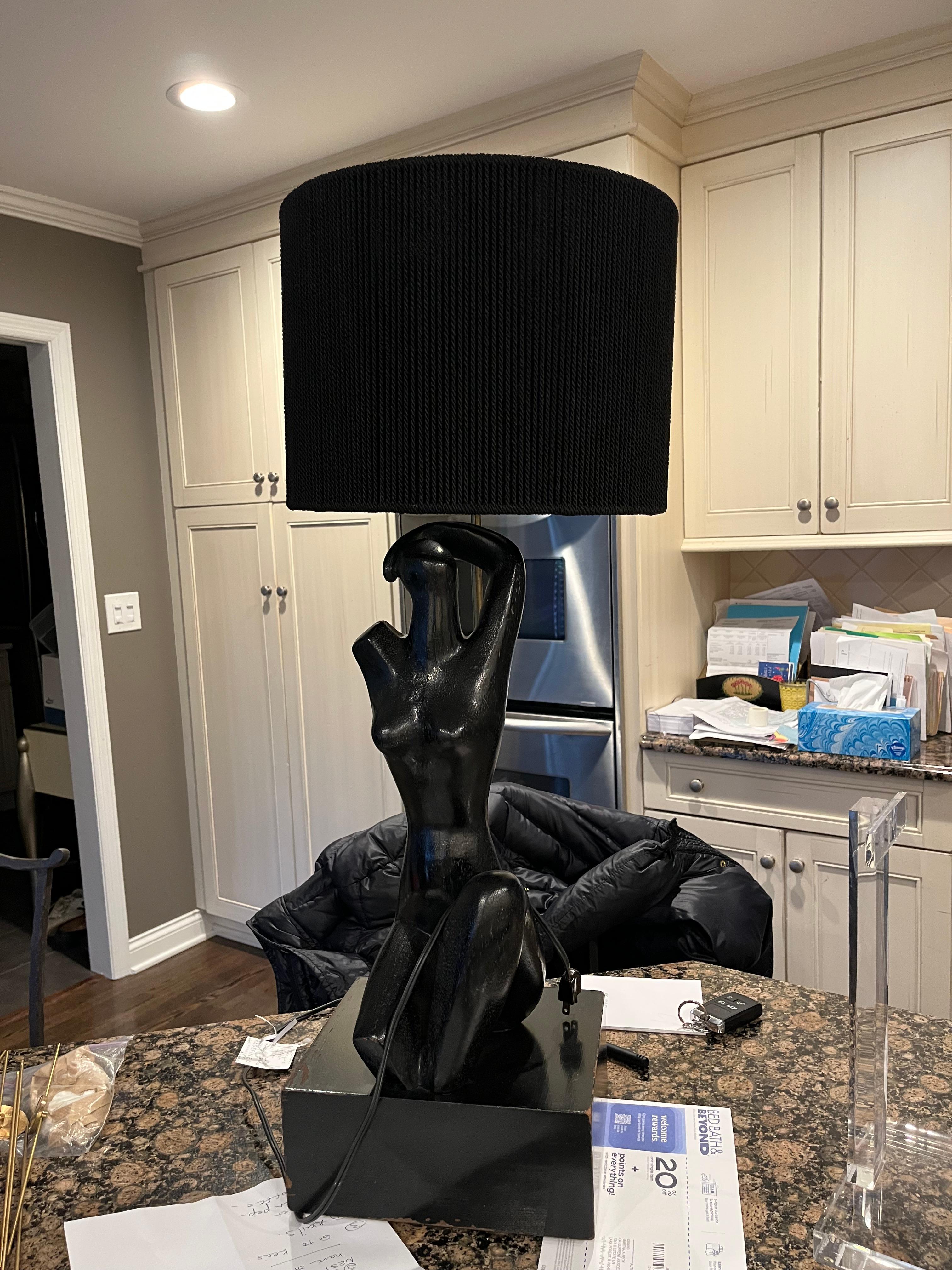 A striking painted wood abstract female sculpture mounted as a table lamp attributed to Yasha Heifitz. This lamp was once featured in a book by Kelly Wearstler.
