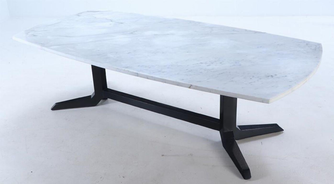 An ebonized marble top dining table circa 1960 having a thick carrara marble top.
