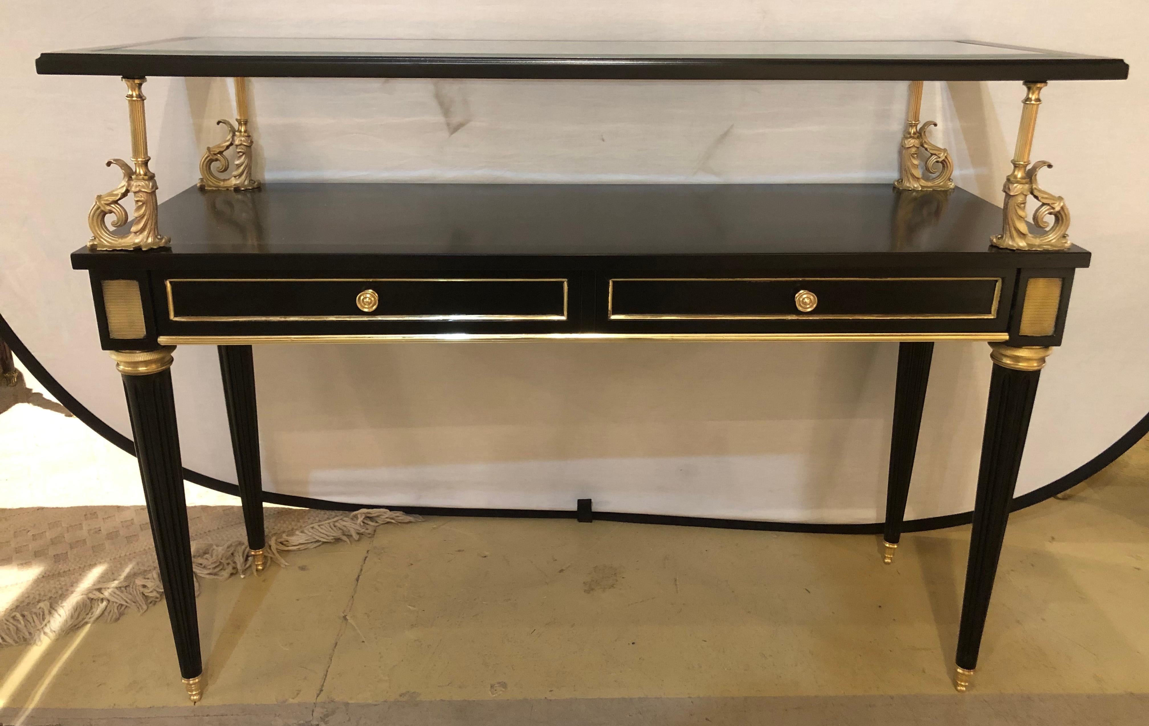An ebony and bronze mounted Hollywood Regency serving cart or étagère. Server / Console table in the manner of Maison Jansen. The sleek and stylish case having bronze sabots leading to tapering reeded legs terminating in bronze circular capitals