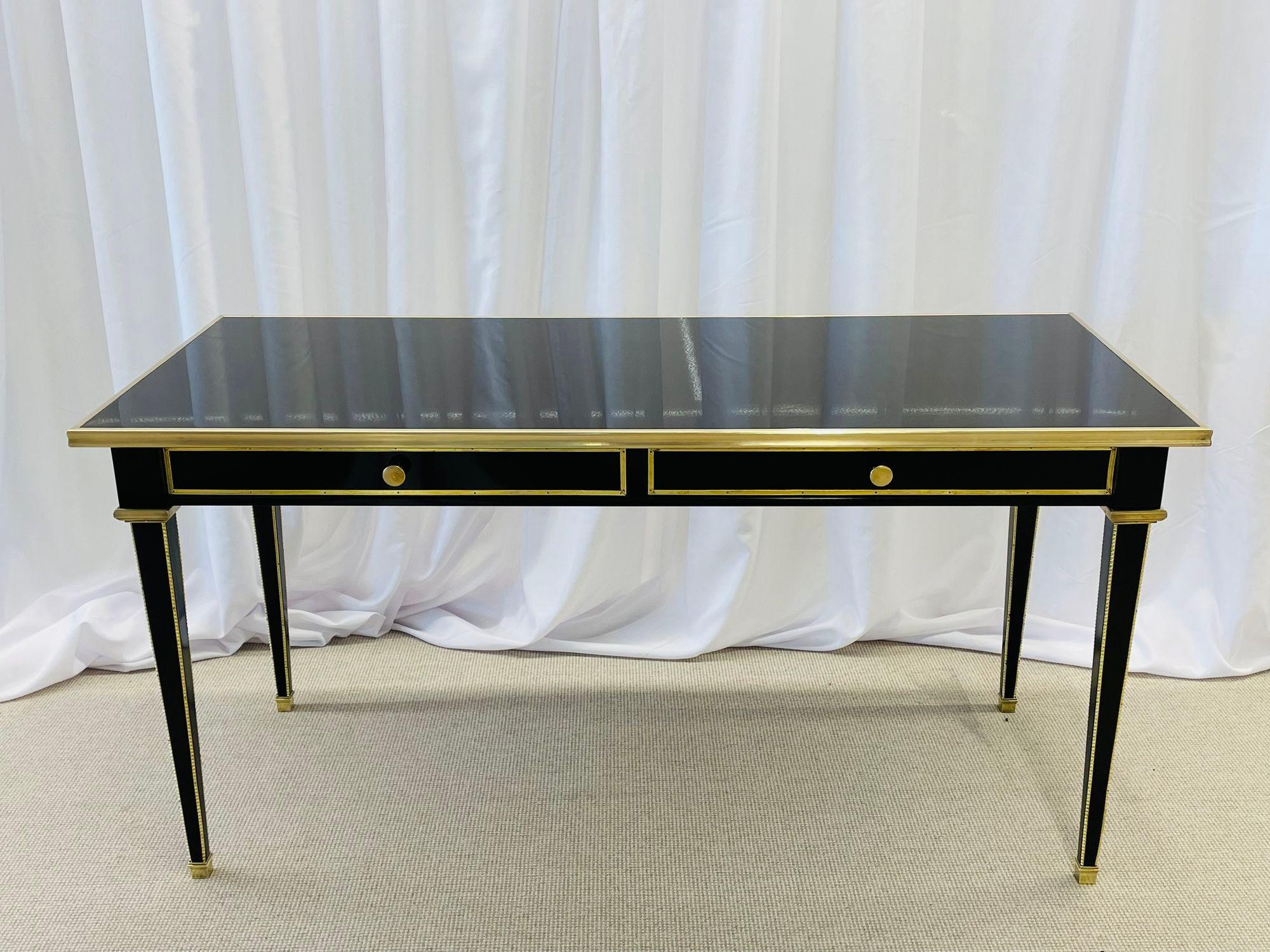 An Ebony French desk, writing table or vanity, Maison Jansen inspired, bronze, fully refinished
Stunning desk or writing table in the manner of Maison Jansen having a magnificent finish of black lacquer. The bronze reeded on all side legs terminate