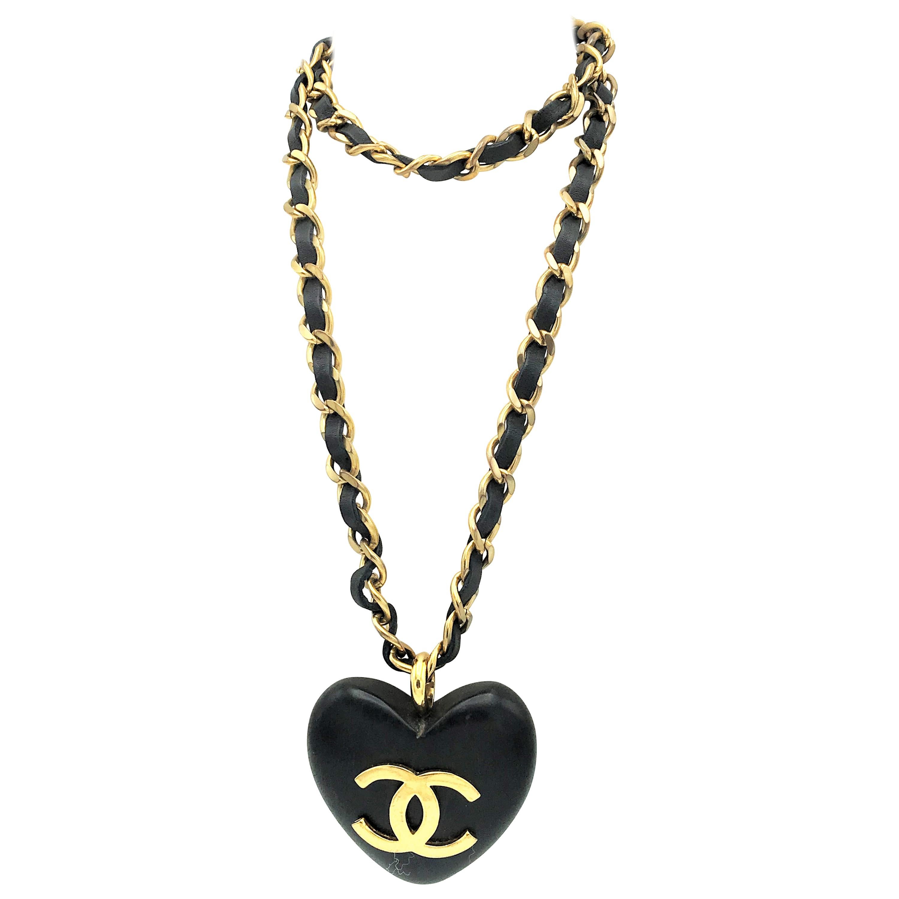 An Ebony Heart hangs on the iconic Chanel chain with leather sign. 1990