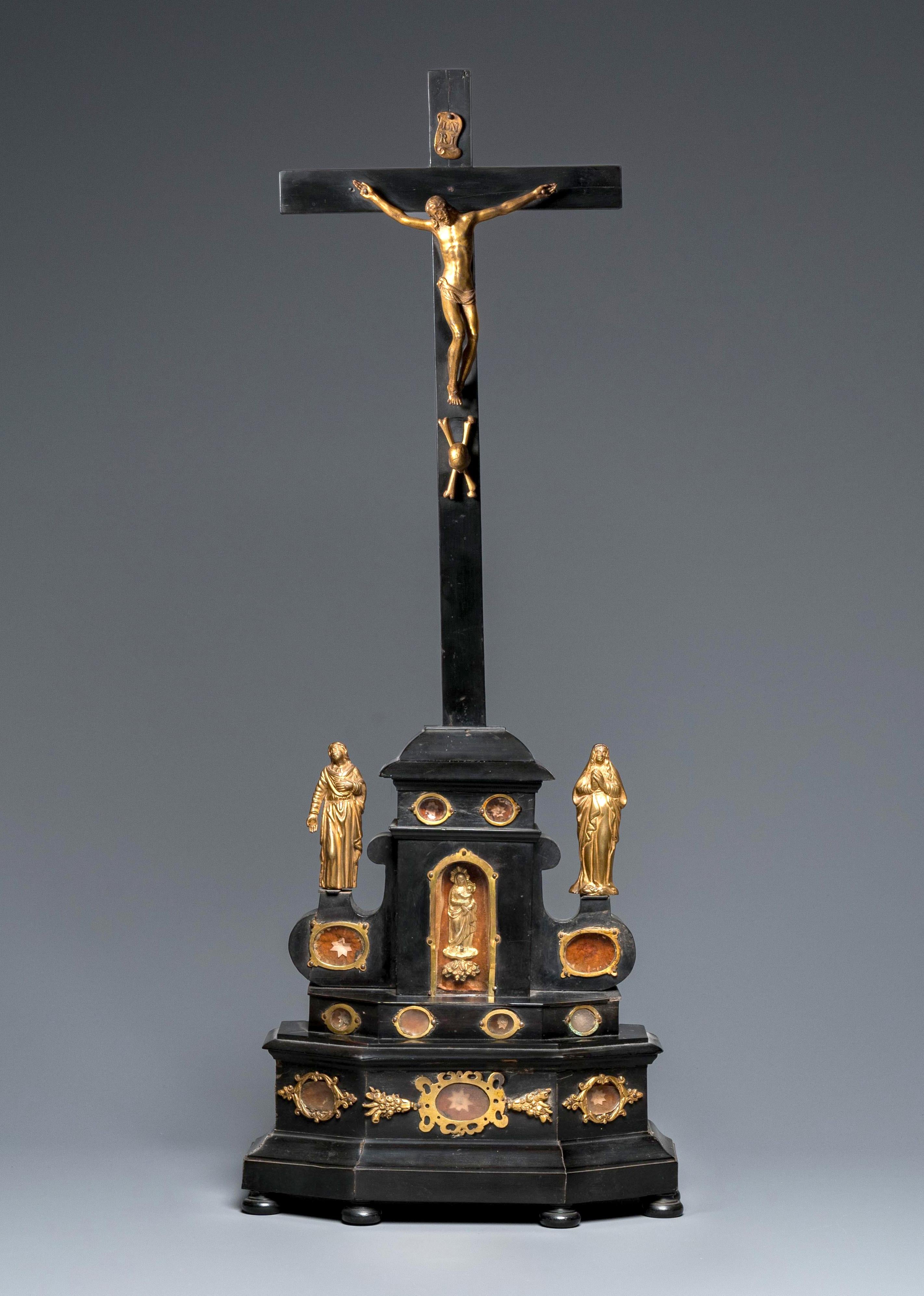 Anonymous (corpus after a model by Giambologna)
circa 1700; Netherlandish or Northern Rhinish
Ebonized wood, gilt bronze appliques and statuettes, textiles and relics

Approximate size: 75 cm (h)

The present altar cross features a gilt bronze
