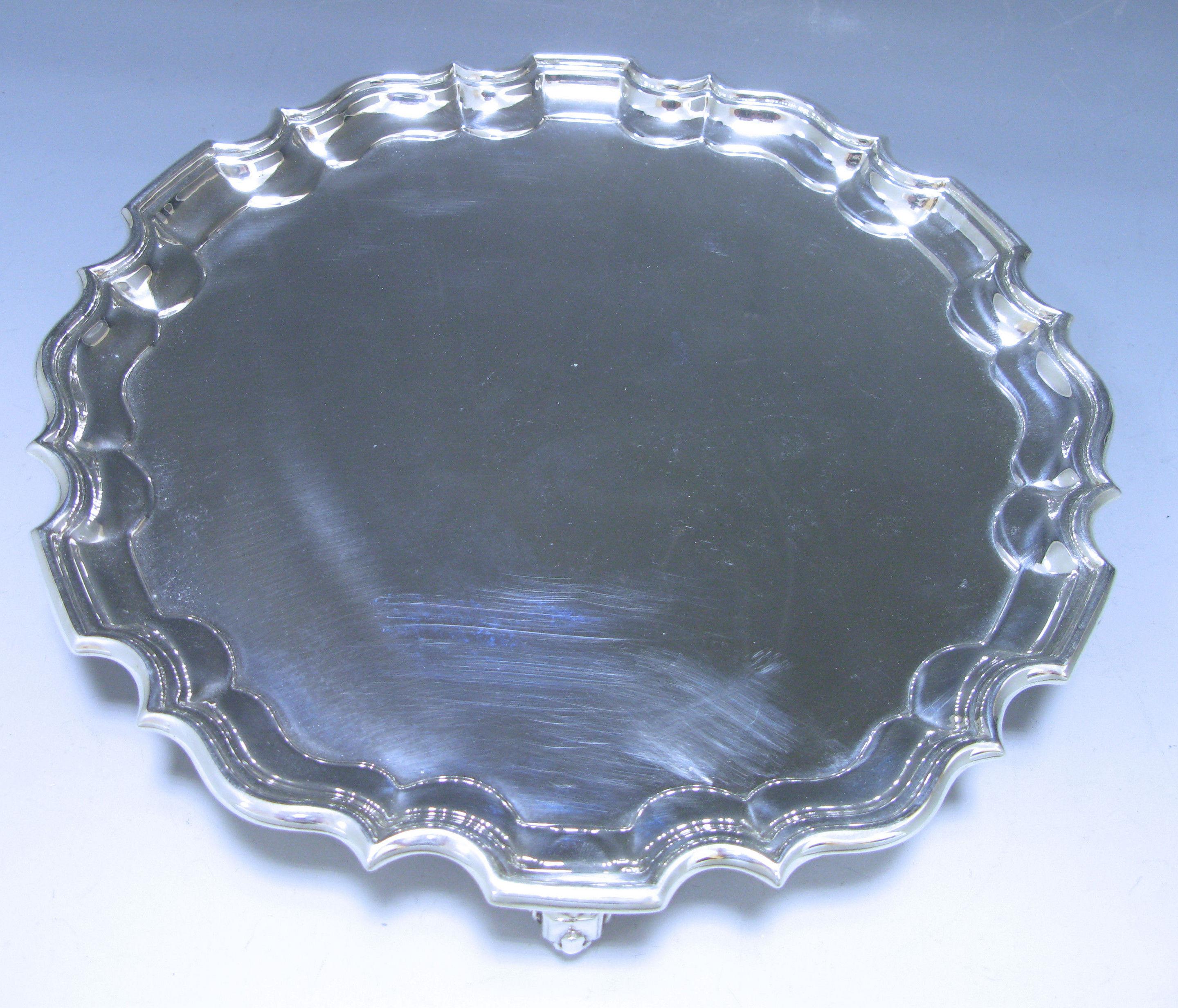 An elegant Edwardian antique silver Salver of circular form with Pie-Crust border standing on three scrolling hoof style feet. 

Dimensions 10 inches, 25.4 cm.