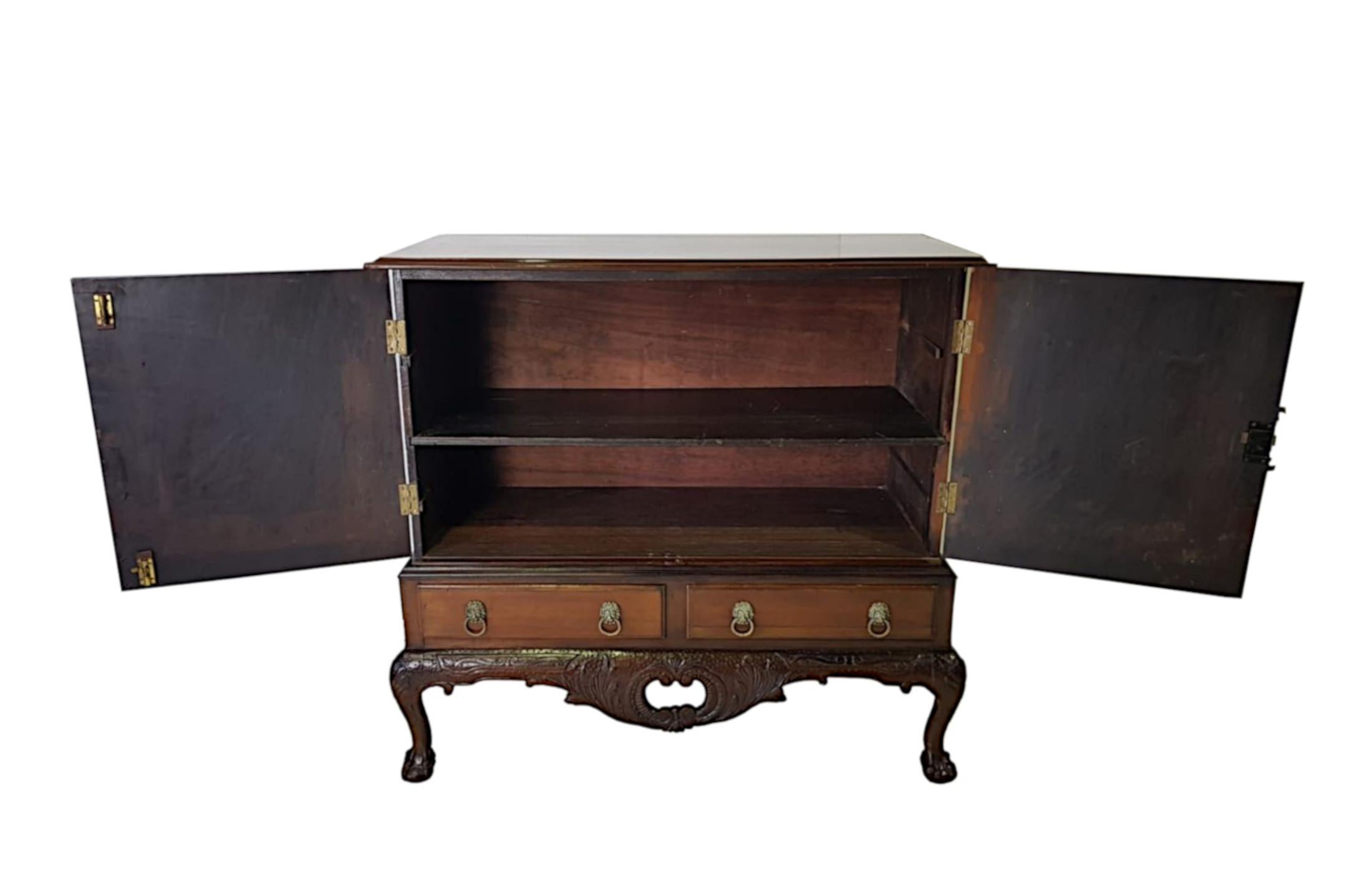 An Edwardian mahogany blanket press of rectangular form in the manner of Thomas Chippendale. The shaped and moulded top raised over two doors with shaped brass hinges, escutcheon and reeded closing slip opening to reveal shelved interior, supported