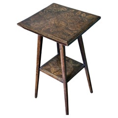 An Edwardian Carved Oak Etagere or Occasional Table