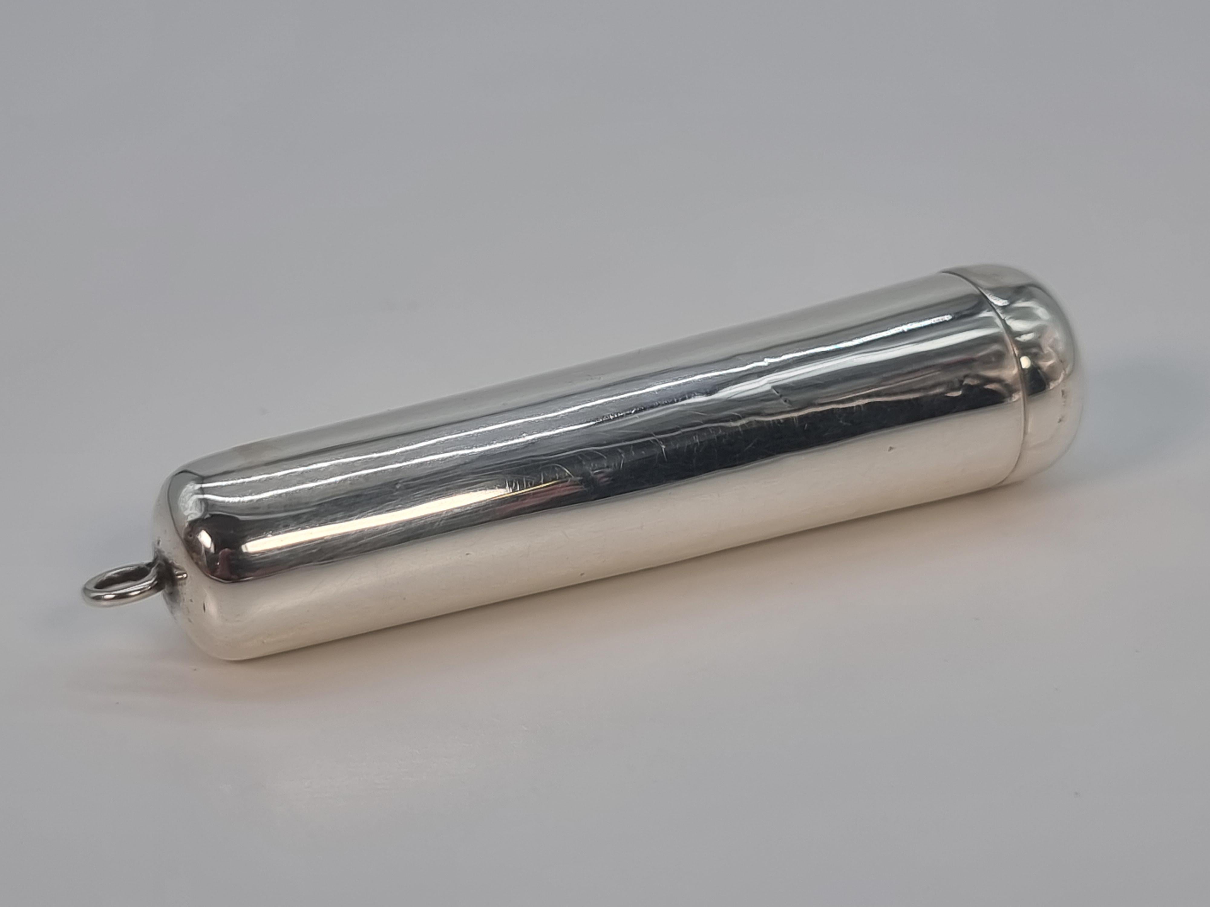 A silver cased cheroot holder made from amber in three sections with a 9ct gold mounted rim.

The case is designed to be attached by the ring to a double Albert watch chain and sit in a waistcoat pocket. It has a hinged lid that is hallmarked on the