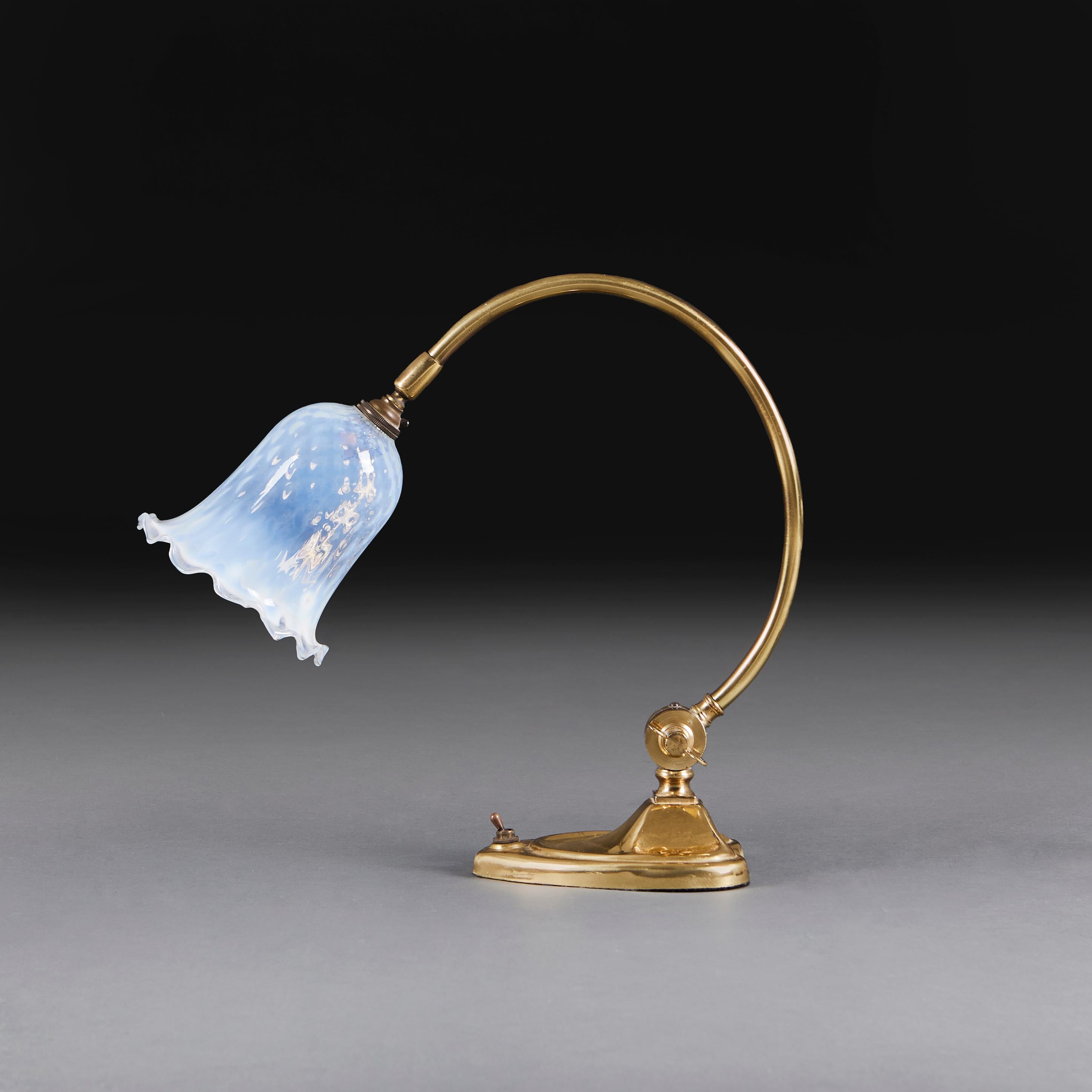 England, circa 1910

An Edwardian curved arm brass desk lamp, with original switch to the base, and Vaseline glass lampshade with wavy edge, after W. A. S. Benson.

Height      37.00cm
Width       13.00cm
Depth       34.00cm

Please note:

Currently