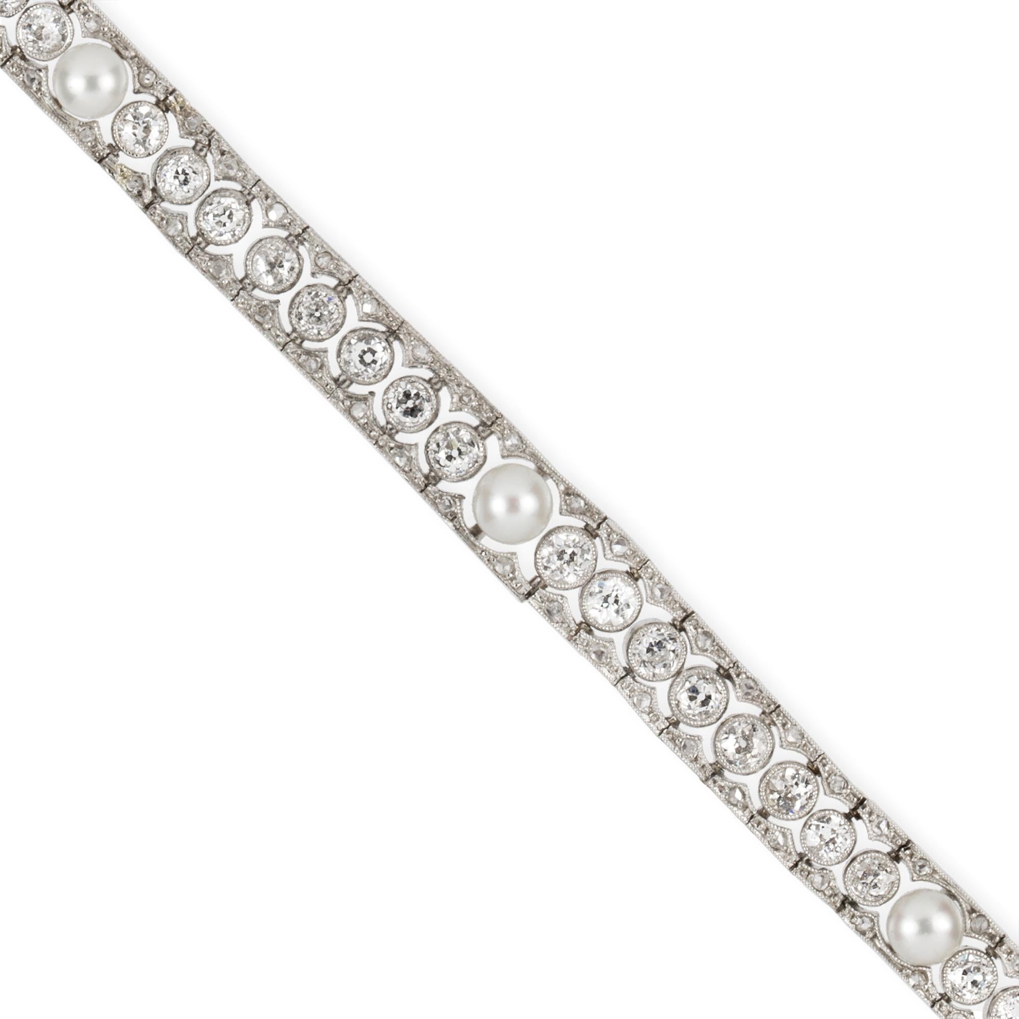 An Edwardian diamond and pearl bracelet by Skinner & Co, set with a line of graduated old-cut diamonds set either side with a scalloped edged diamond-set border all in millegrain, estimated total diamond weight approximately 5 carats, with five