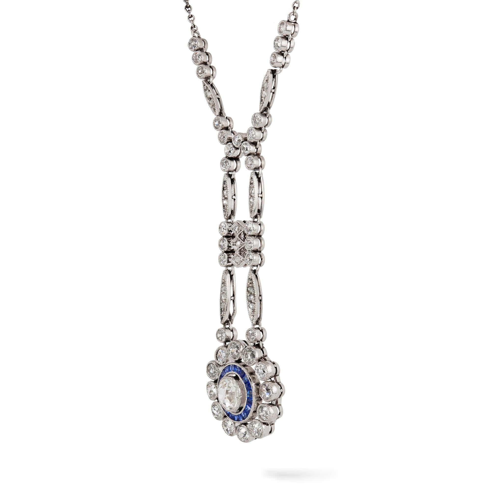 An Edwardian diamond and sapphire necklet, to the centre an old European-cut diamond estimated to weigh 0.75 carats, surrounded by a row of calibrated sapphires and an outer row of twelve round old-cut diamonds, all suspended by a run consisted of