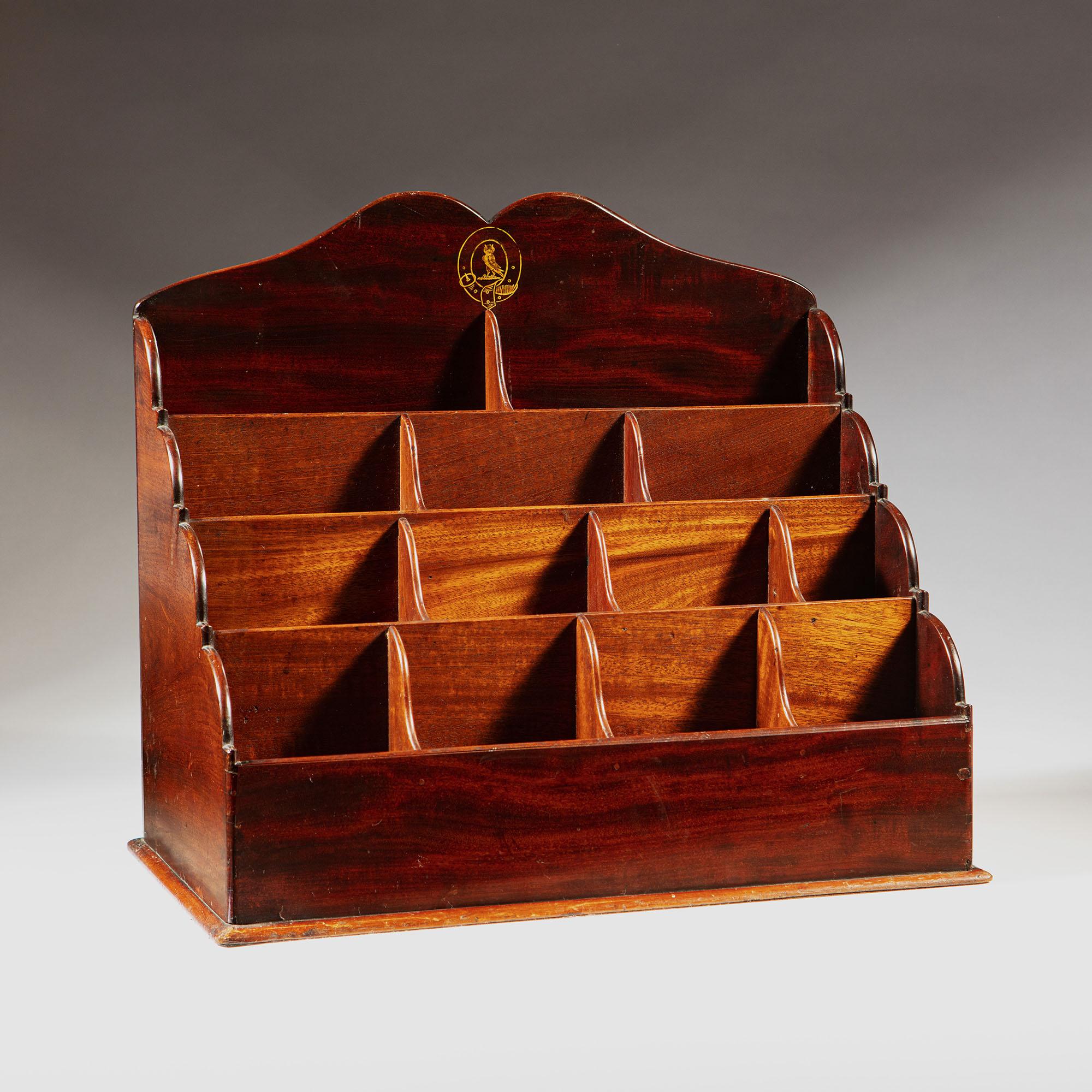 A late 19th century flame mahogany waterfall desk organizer or letter rack, with owl coat of arms to the pediment and thirteen storage compartments.