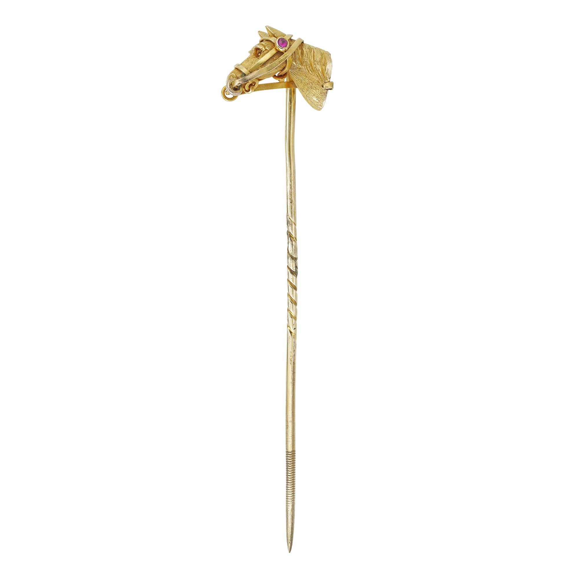 An Edwardian horse-head stick-pin, the realistically carved horse head, set with a cabochon-cut ruby, made in yellow gold with gold pin fitting, circa 1905, the jewelled part measuring 1.5 x 1.1cm, gross weight 4.4 grams.

This wonderful Edwardian