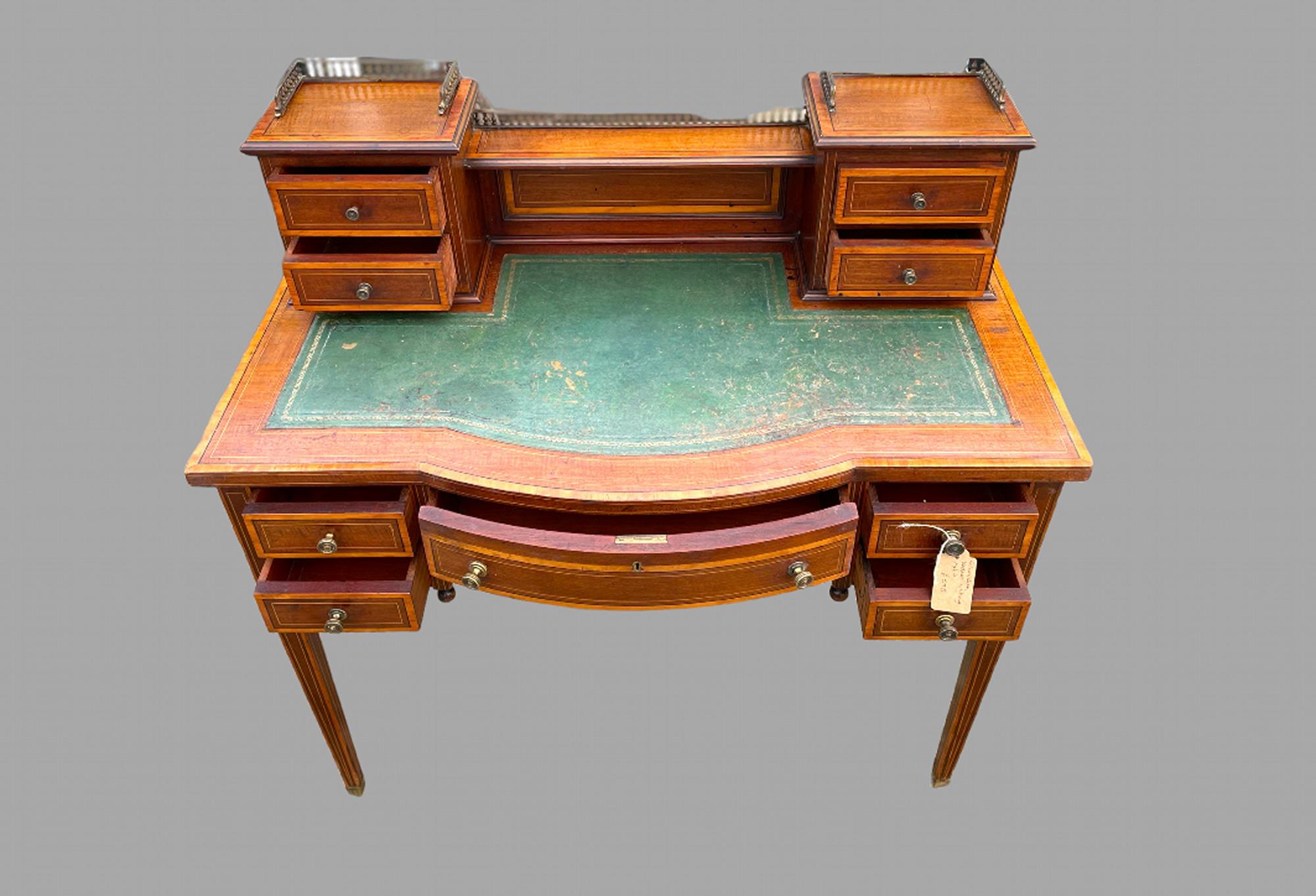 An Attractive Mahogany and Satinwood Edwardian Ladys Desk with two small drawers each side on top piece and two small drawers each side with larger middle drawer to desk. Total Height with top is 96 cm, slight wear to leather but ok and on castors