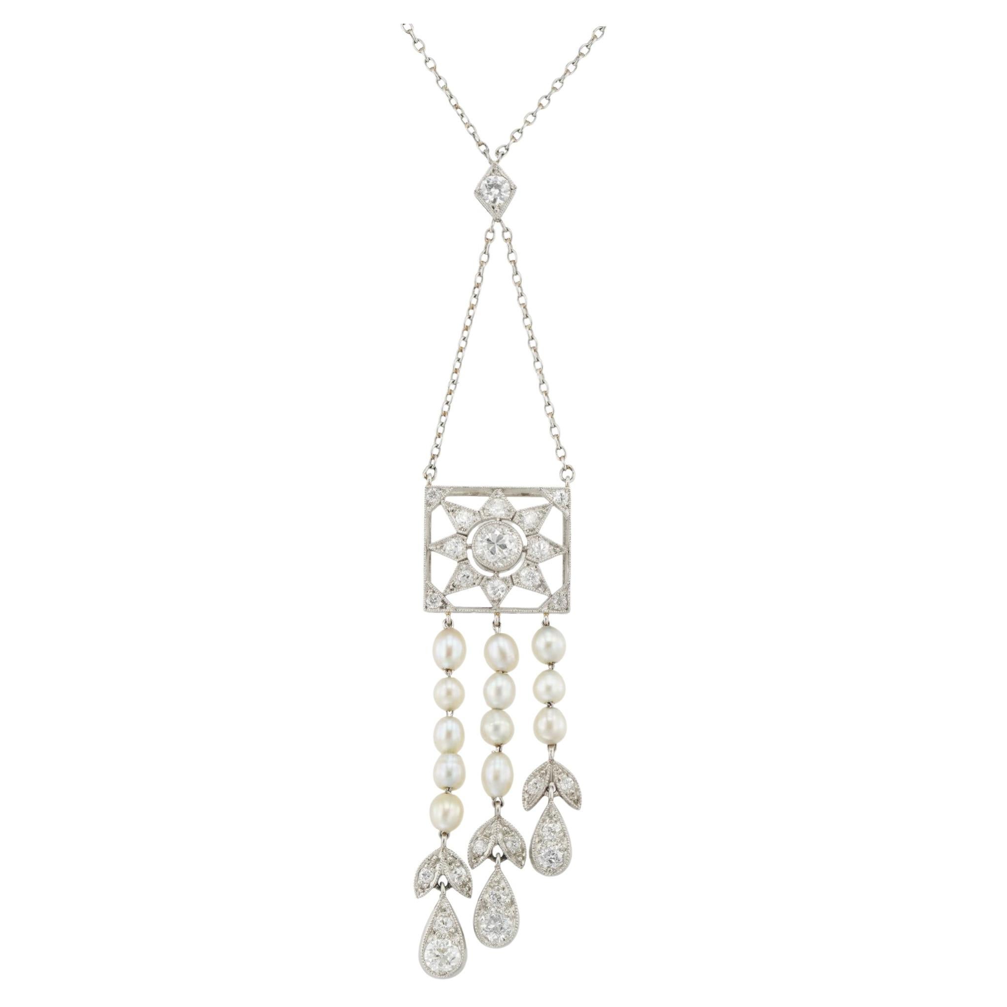 An Edwardian natural pearl and diamond pendant necklace