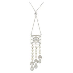 An Edwardian natural pearl and diamond pendant necklace
