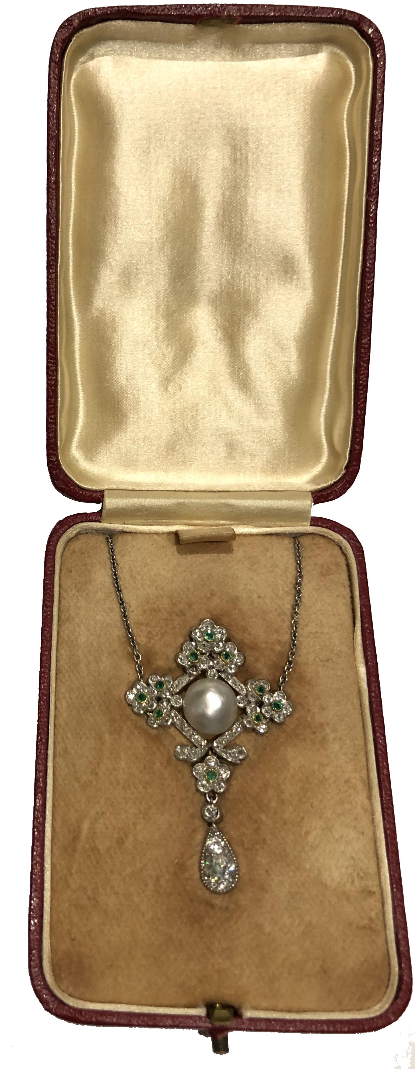 A Delicate Edwardian Platinum Natural Oriental Pearl, Emerald & Diamond Pendant, the lobed flowerhead lozenge cluster, set at the centre with a bouton pearl measuring 9.3mm, within a prunus blossom frame set with circular-cut diamonds, decorated