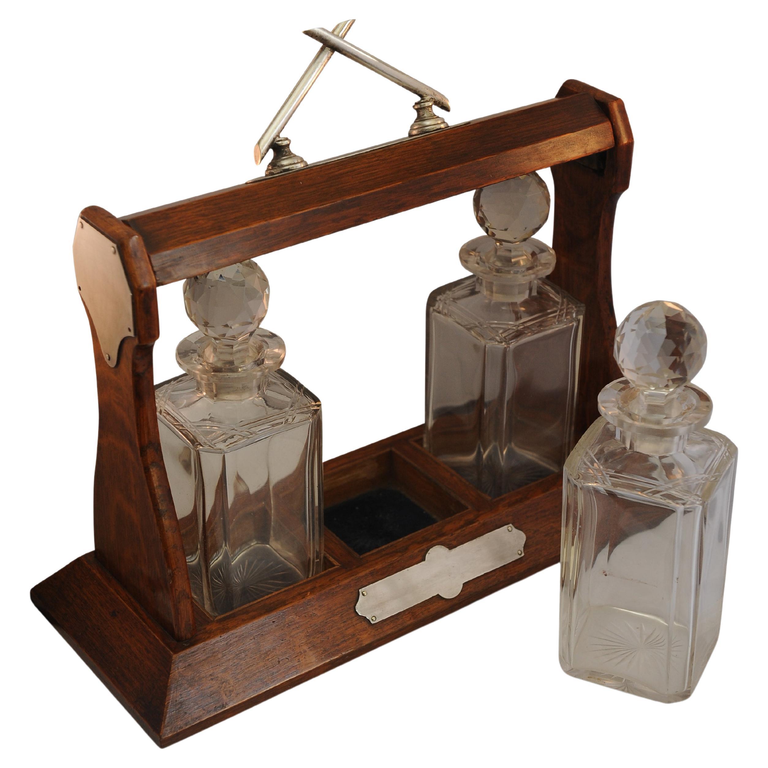 British Late Victorian Oak Decanter Tantalus With Three Cut Glass Decanters