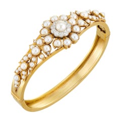 An Edwardian pearl and diamond bangle