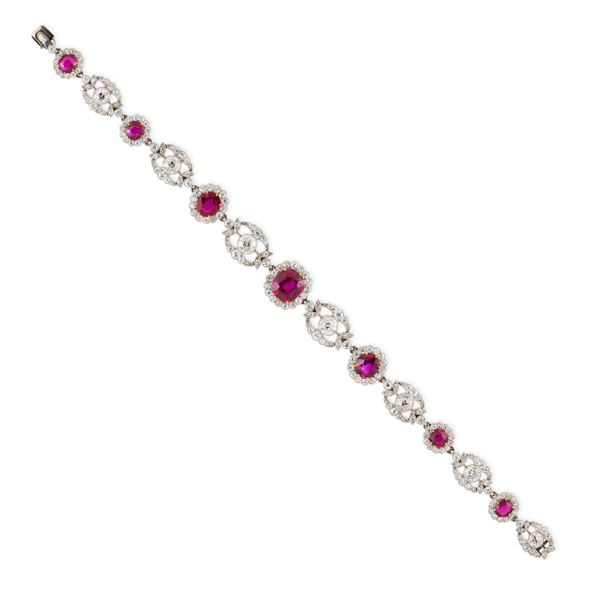 An Edwardian ruby and diamond bracelet, the seven cushion-cut rubies weighing 7.22 carats, accompanied by GCS Report stating to be of Burmese origin with no indication of heating, each surrounded by a diamond-set cluster, connected with openwork