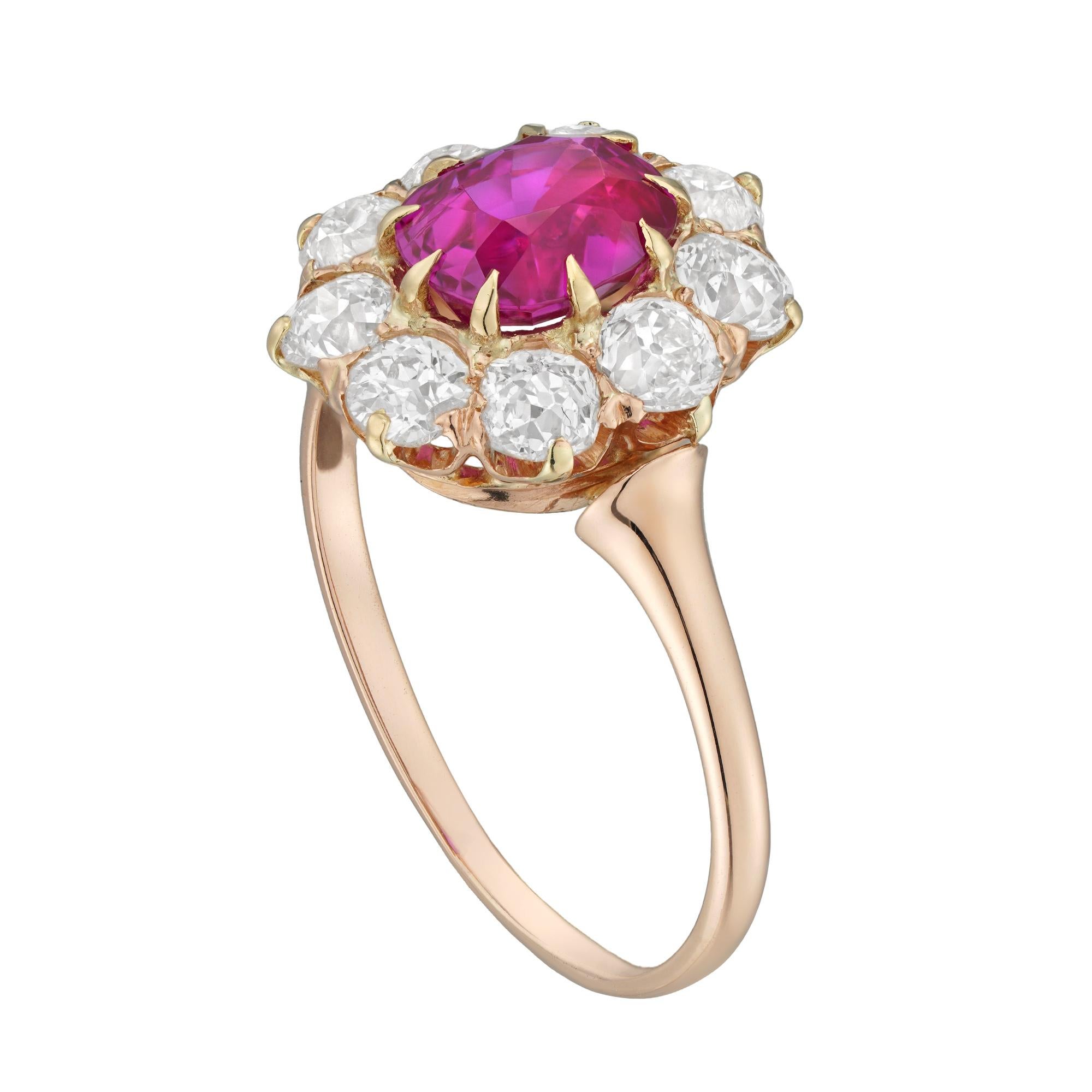 An Edwardian ruby and diamond cluster ring, the oval faceted ruby weighting 1.66 carats, accompanied by Gem & Pearl laboratory report stating to be of Burmese origin with no indication of heating, surrounded by seven old brilliant-cut diamonds