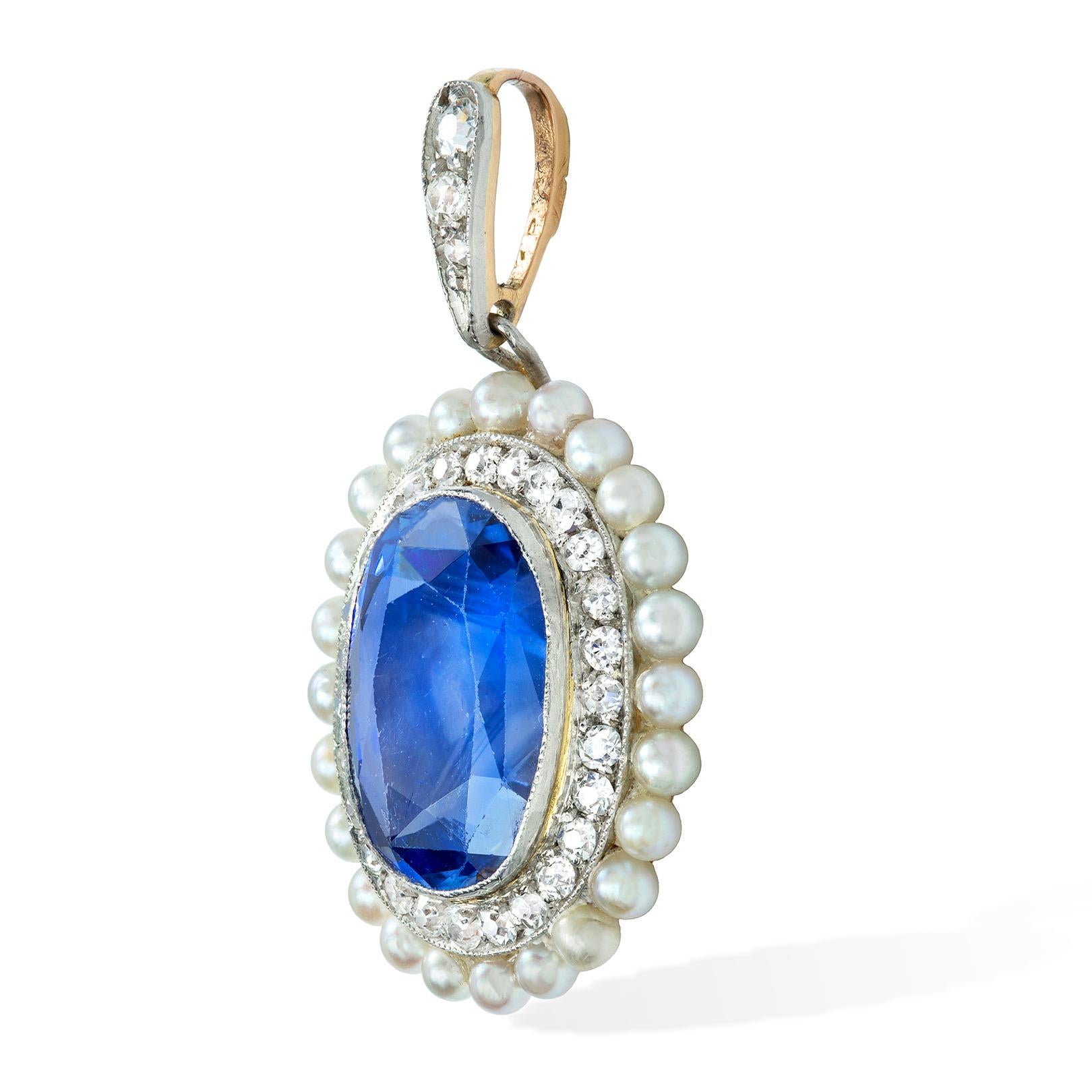 A Belle Époque sapphire diamond and pearl pendant, the oval-cut faceted sapphire weighing approximately 6.60 carats, accompanied by GCS Report 77116-67 stating to be of Sri-Lankan origin, with no indication of heat treatment, surrounded by