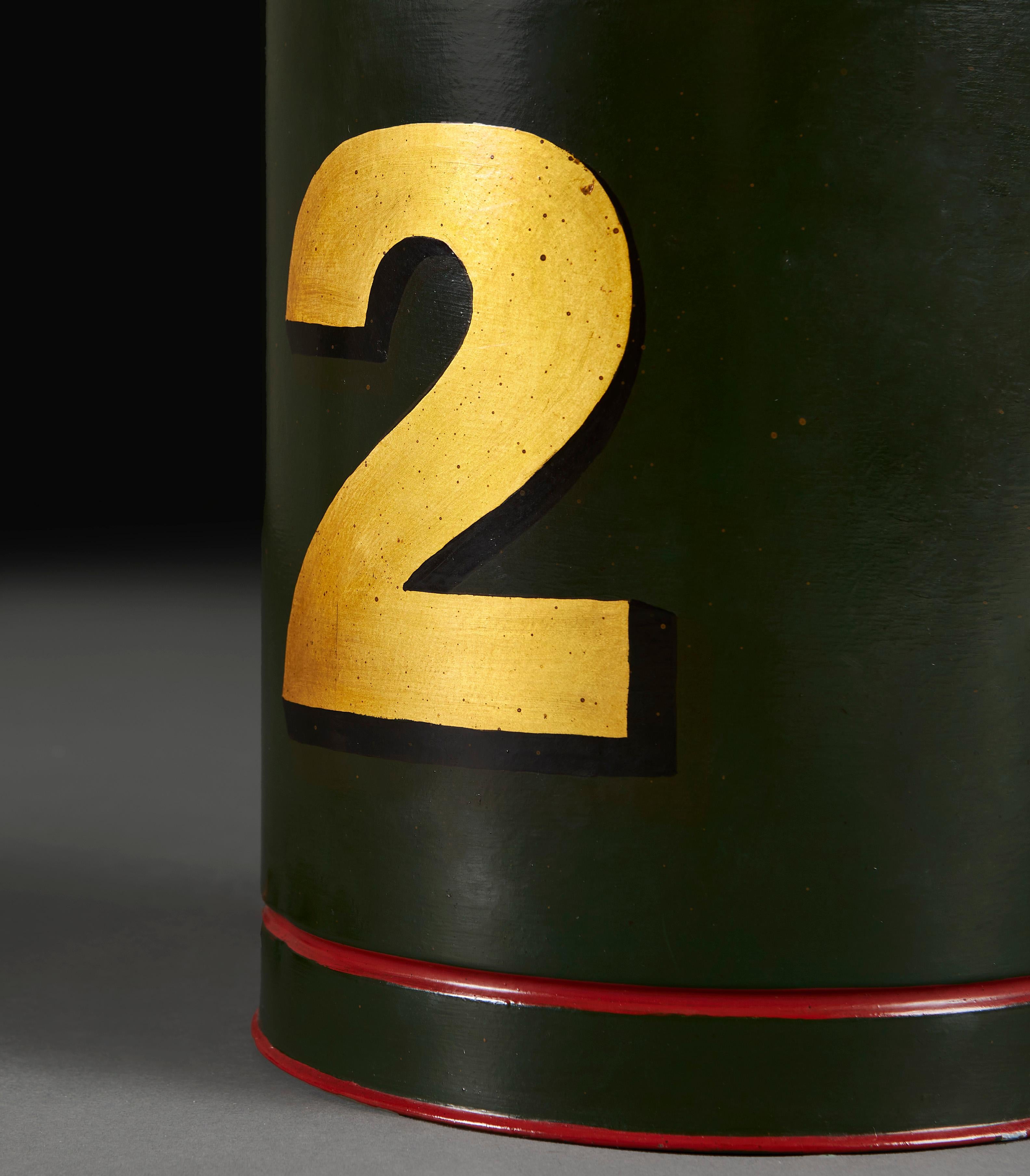 Angleterre, vers 1930

Une boîte à thé édouardienne en guise de lampe, le fond vert avec des anneaux concentriques rouges à la base et au sommet, décorée d'un numéro 2 doré sur le devant. 

Veuillez noter : 
Ne comprend pas l'abat-jour. La lampe a