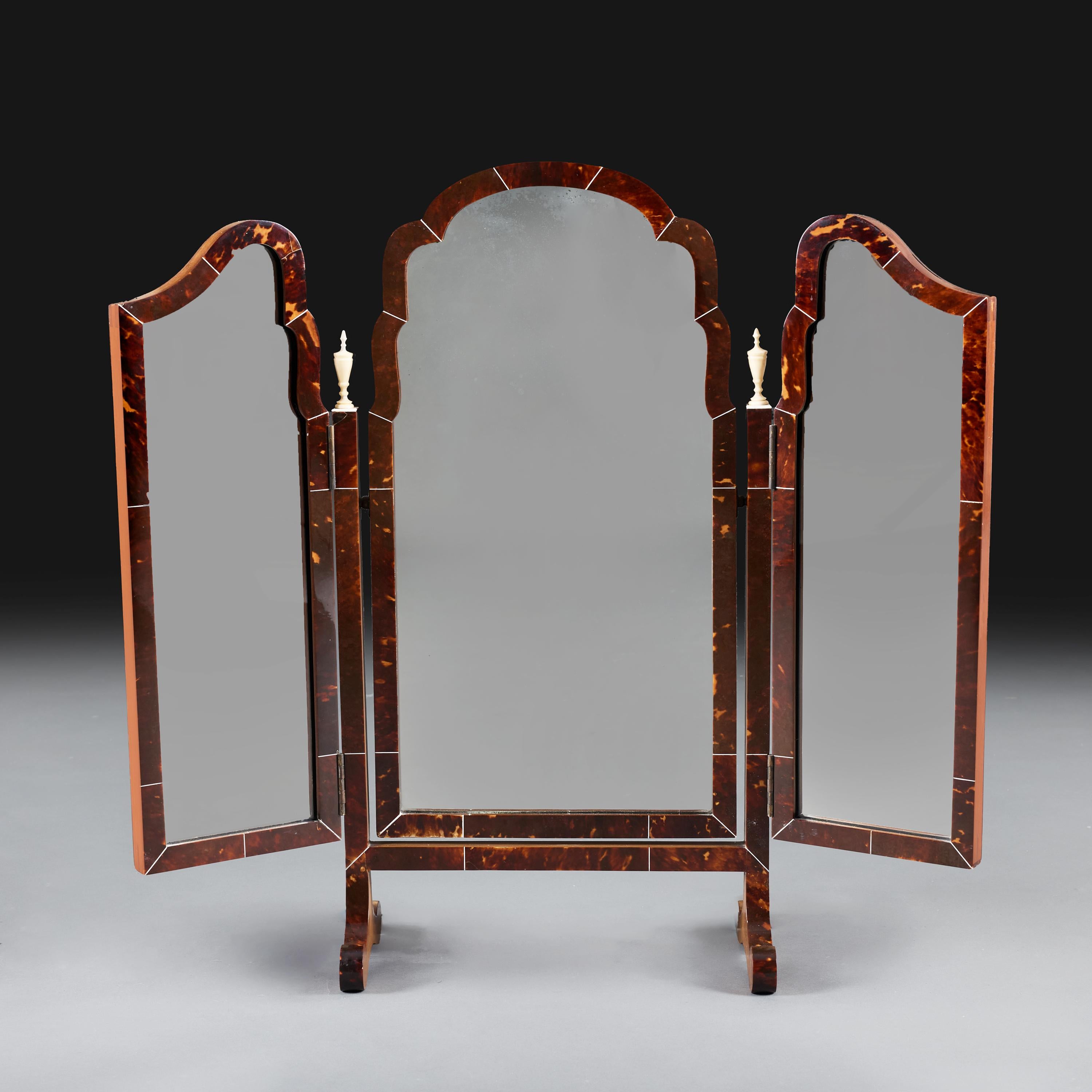 England, circa 1910

An Edwardian triptych dressing mirror with tortoiseshell frame supported on two scrolling feet, with ivorine string partitions and two urn finials.

Height 65.00cm
Width open 69.00cm
Depth 16.00cm