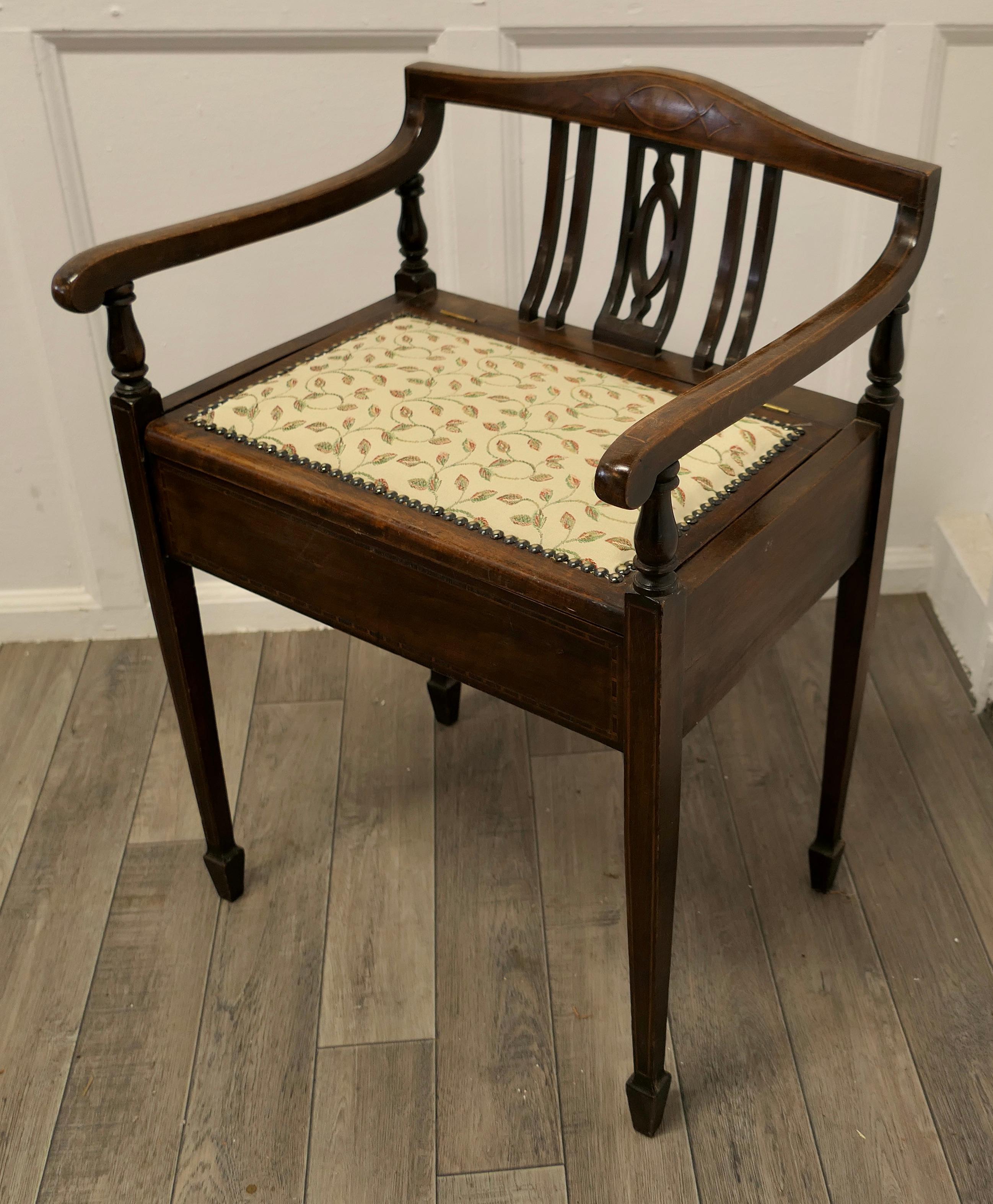 An Edwardian upholstered piano stool.
 
This elegant piano is in very good condition, it has a low back with a little carved decoration, the seat has been covered with a fine woven linen material, the lid of the stool opens for the storage of