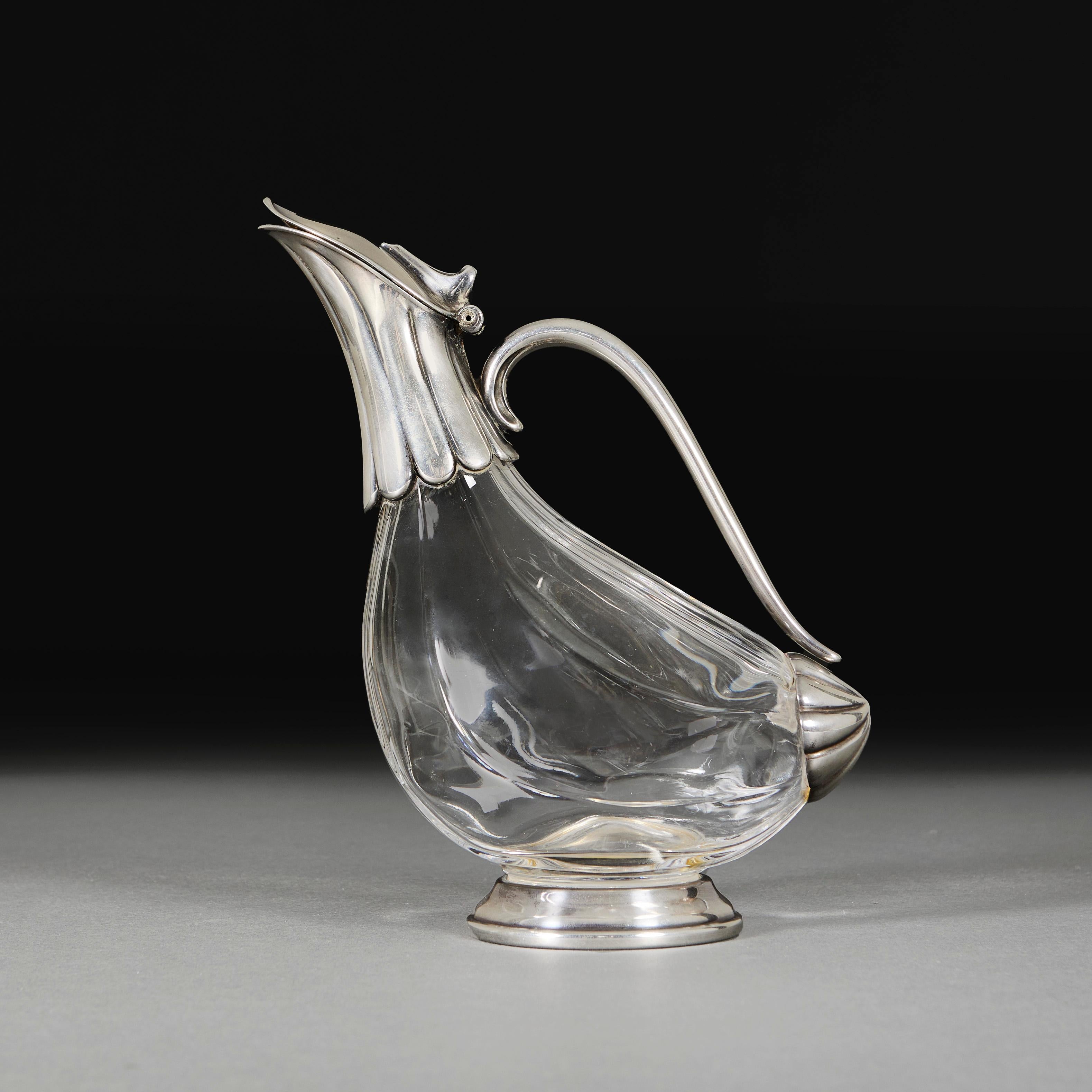 England, circa 1910

An Edwardian glass and silver decanter of zoomorphic form, imitating a duck, standing on a circular plinth base.

Height     25.00cm

Width      20.00cm

Depth      9.00cm