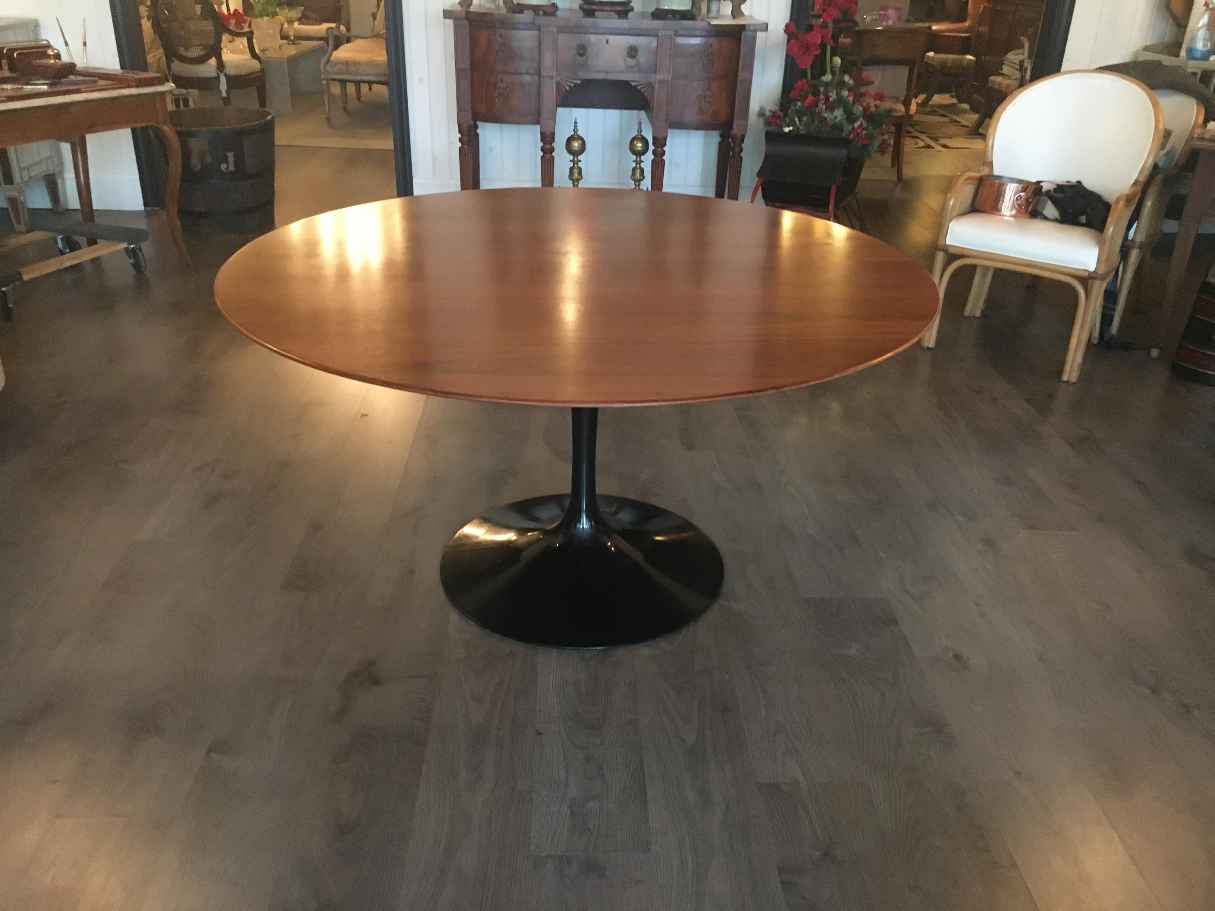 An Eero Saarinen for Knoll tulip table. Rare black base with teak top. Signed Knoll on base. Great floating effect with black base wood top combination.