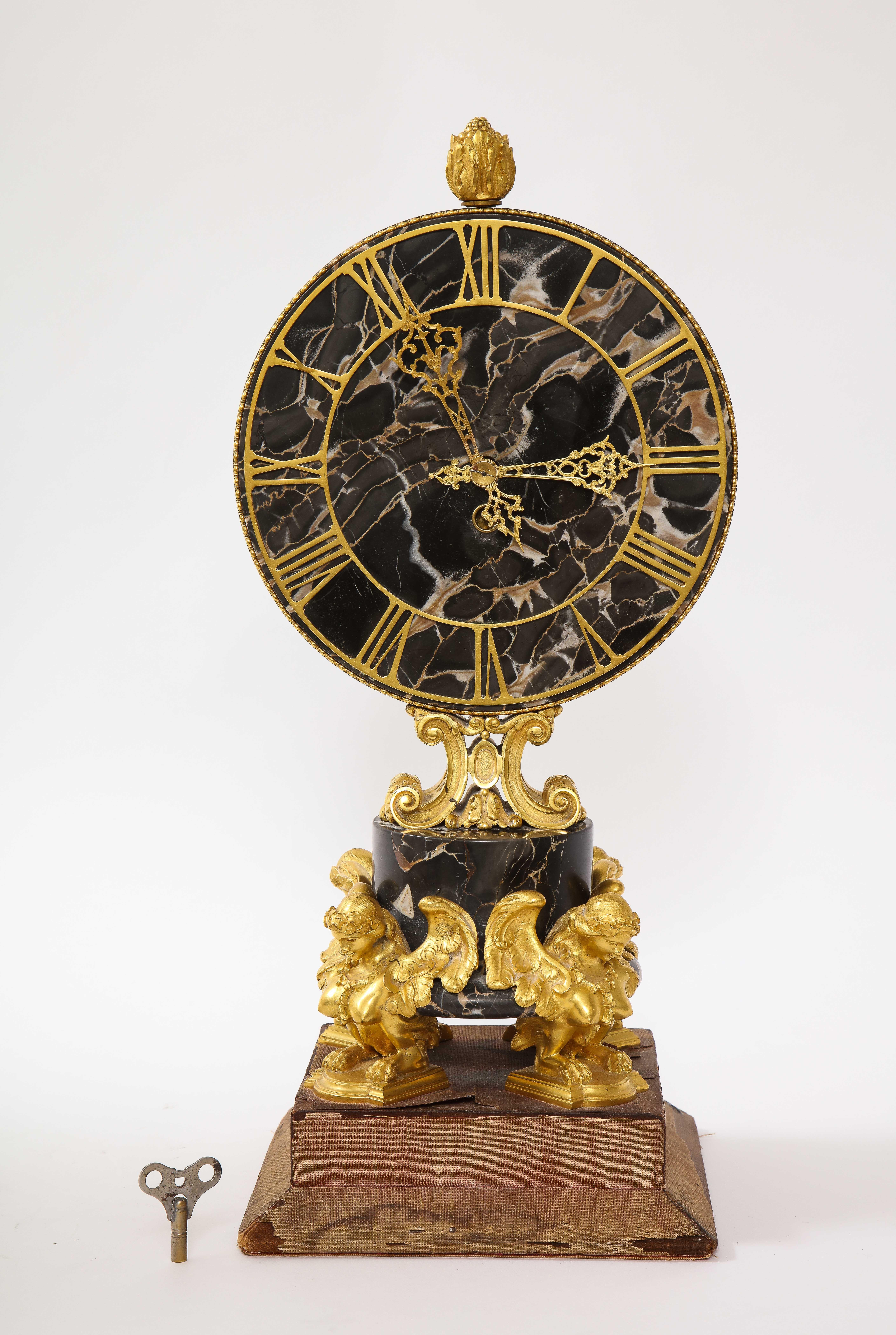 A gorgeous and large E.F. Caldwell black veined marble and dore bronze mounted sphinx legged clock. This is a beautiful mantle clock designed by the great, E.F. Caldwell and Co. The face and mid-section are made of a beautiful hand carved veined