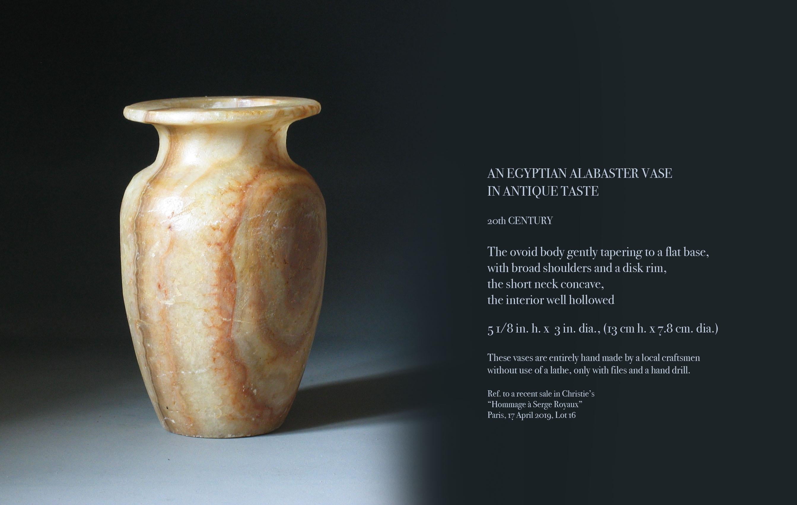 An Egyptian Alabaster vase in antique taste, 20th century. The ovoid body gently tapering to a flat base, with broad shoulders and a disk rim, the short neck is concave, the interior well hollowed. The vase measures 5 1/8