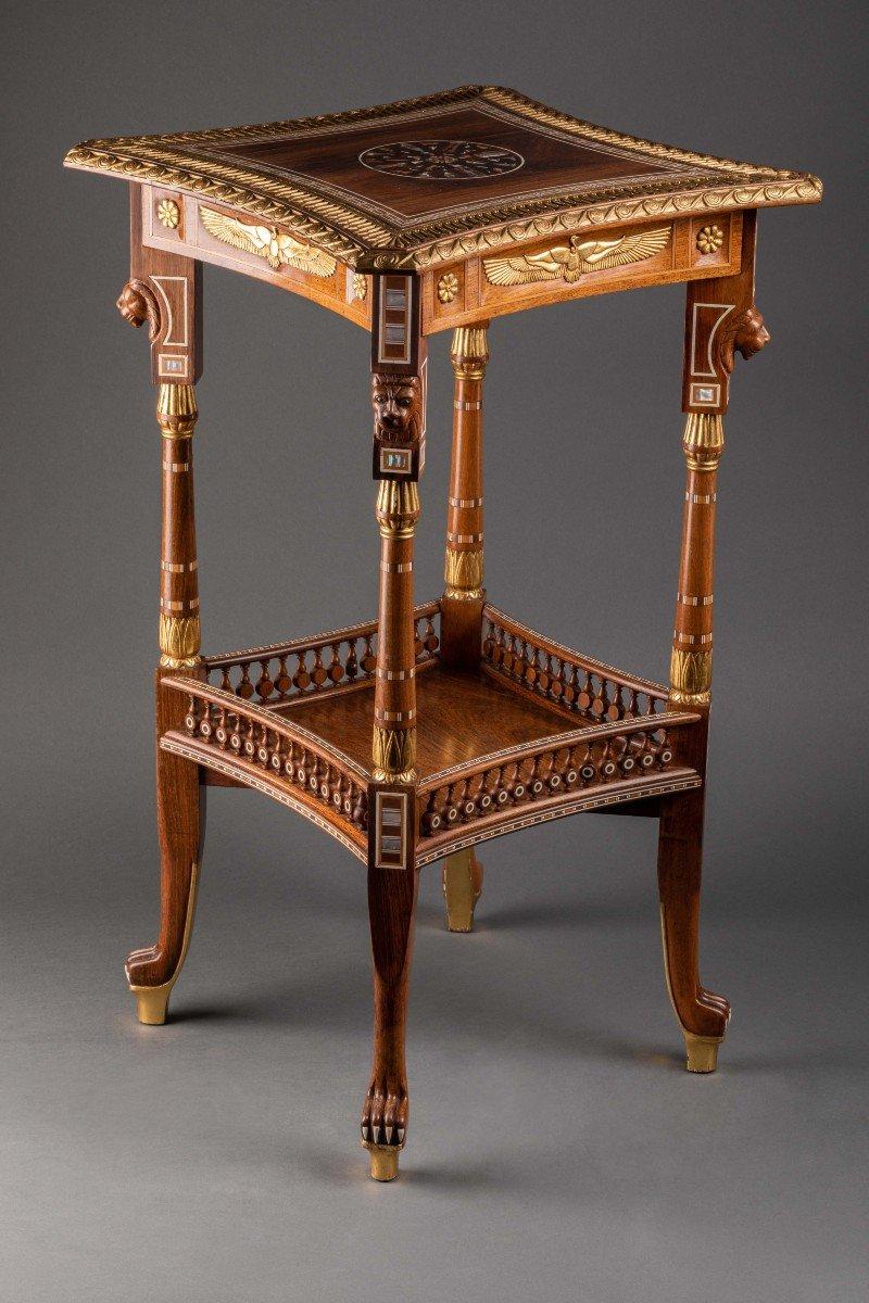 An Egyptian Revival Simulated  Bone Inlaid Parcel Gilt Mahogany Side Table, English in the classical style of Lawrence Alma Tadema attributed to Johnstone, Norman & Co
Sir Lawrence Alma-Tadema (1836-1912) primarily designed furniture himself, but it