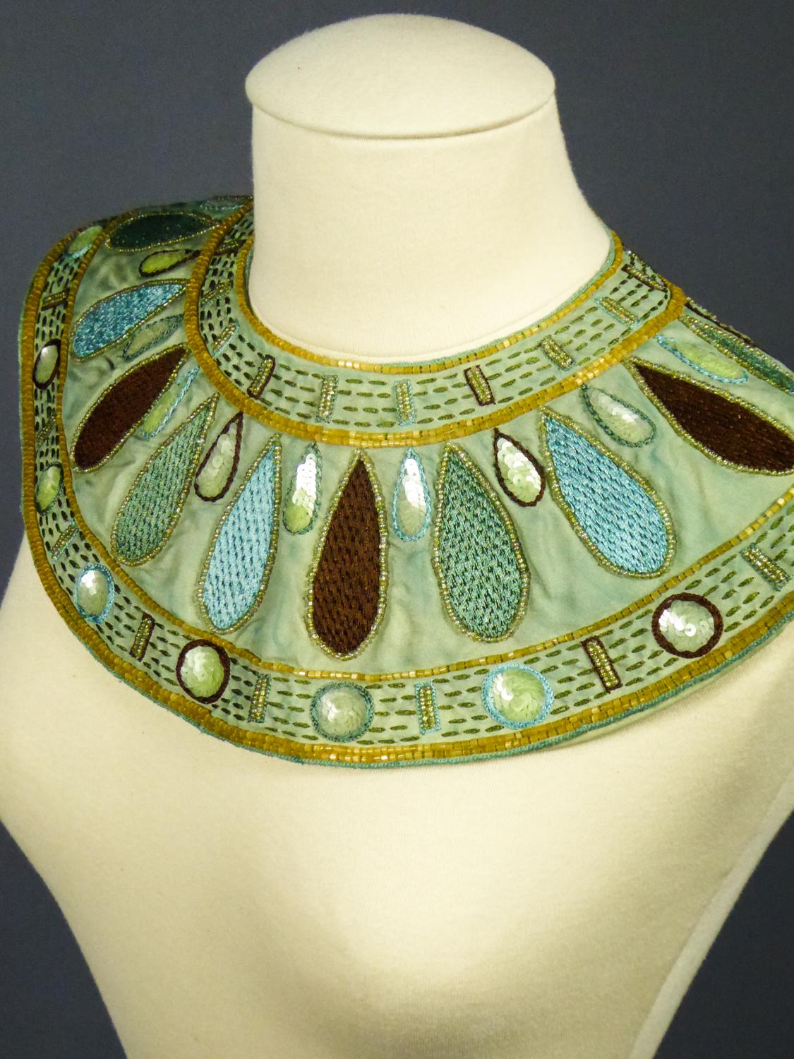 Circa 1940-1960
France

Impressive Egyptian-style collar or jewllery, probably from a film production around the 1950s. Background in sky-blue silk taffeta entirely embroidered with silk threads in chocolate, blue-gray, yellow and turquoise tones.