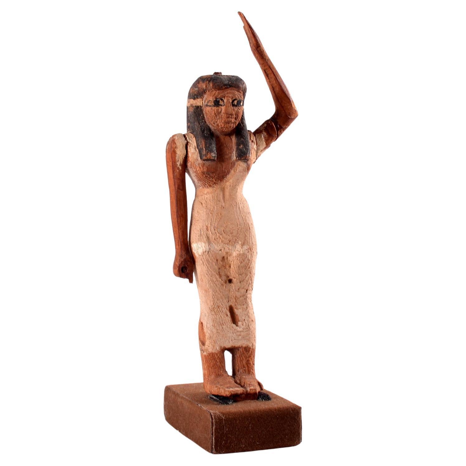 An Egyptian wooden female offering bearer figure, Middle Kingdom For Sale