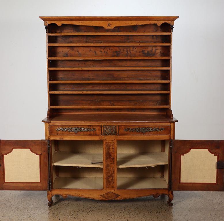 An eighteenth century Two part French vaisselier. The etegere top having an inalid star and resting on a two door base cabinet having steel hardware and burl walnut panels.