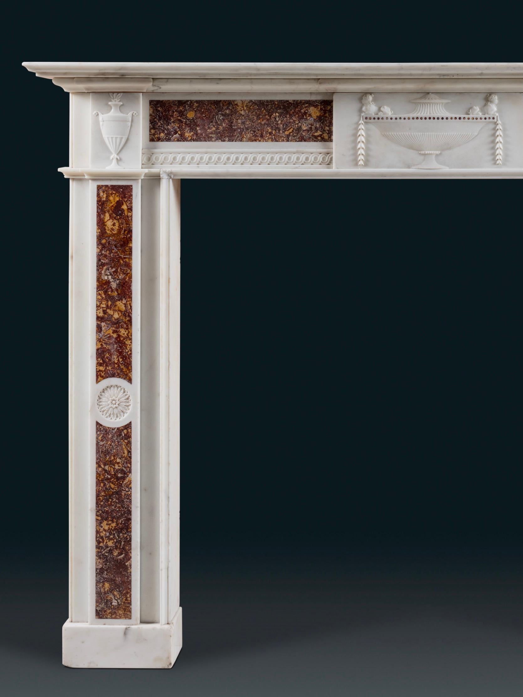 An exceptional 18th century white statuary and Brocatello marble chimneypiece, with tiered shelf, carved central tablet and corner blocks. Antique decorative motifs are employed sparingly yet their use is definitive, imparting throughout the piece a