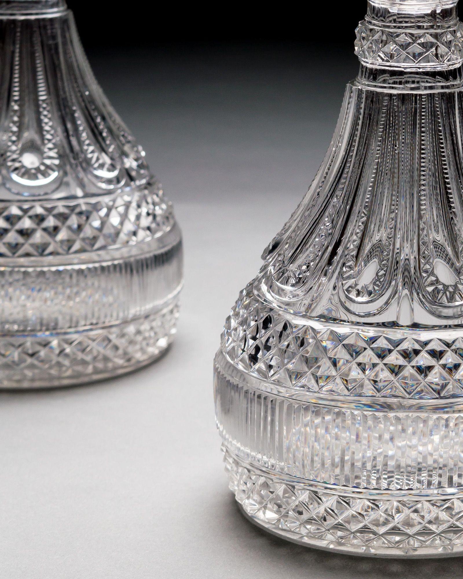 A superb pair of elaborately cut glass semi ships decanters of royal pattern by Perrin & Geddes of Warrington, the base with double diamond bands divided by vertical mitre cuts, tapering to diamond cut gadrooning bodies with diamond neck ring, the