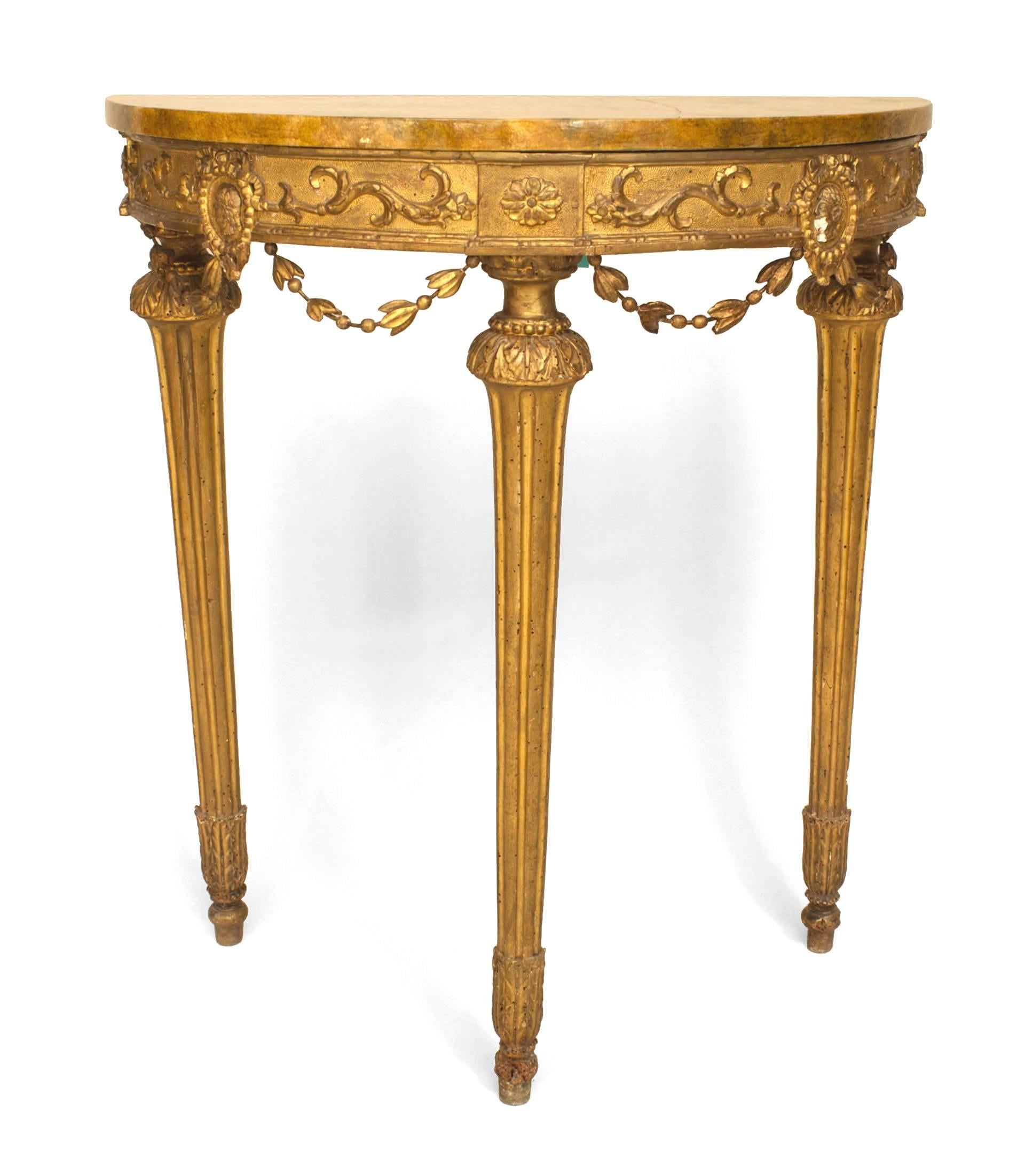 Italian Neo-classic (Late 18th Century) gilt wood demilune console table with a faux painted Sierra marble top above carved festoons and supported on 3 fluted legs.
