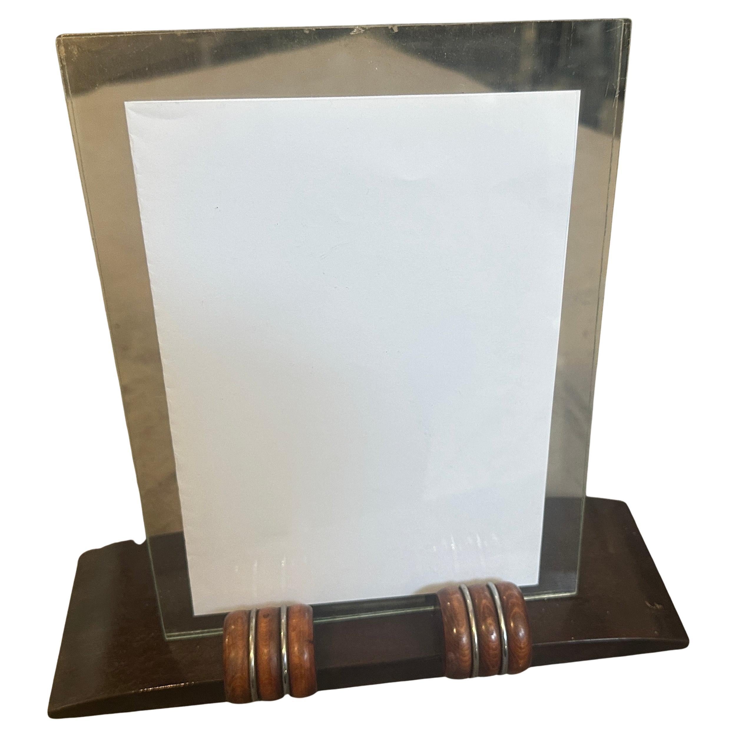 This stunning and authentic 1930s French Picture Frame is a quintessential piece of Art Deco design. This elegant frame perfectly captures the streamlined sophistication of the era, showcasing a rich, dark-stained wood base with a gracefully curved